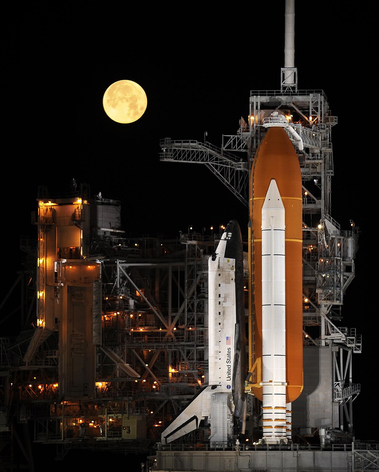 Space Shuttle Discovery under a full moon, 03-11-09