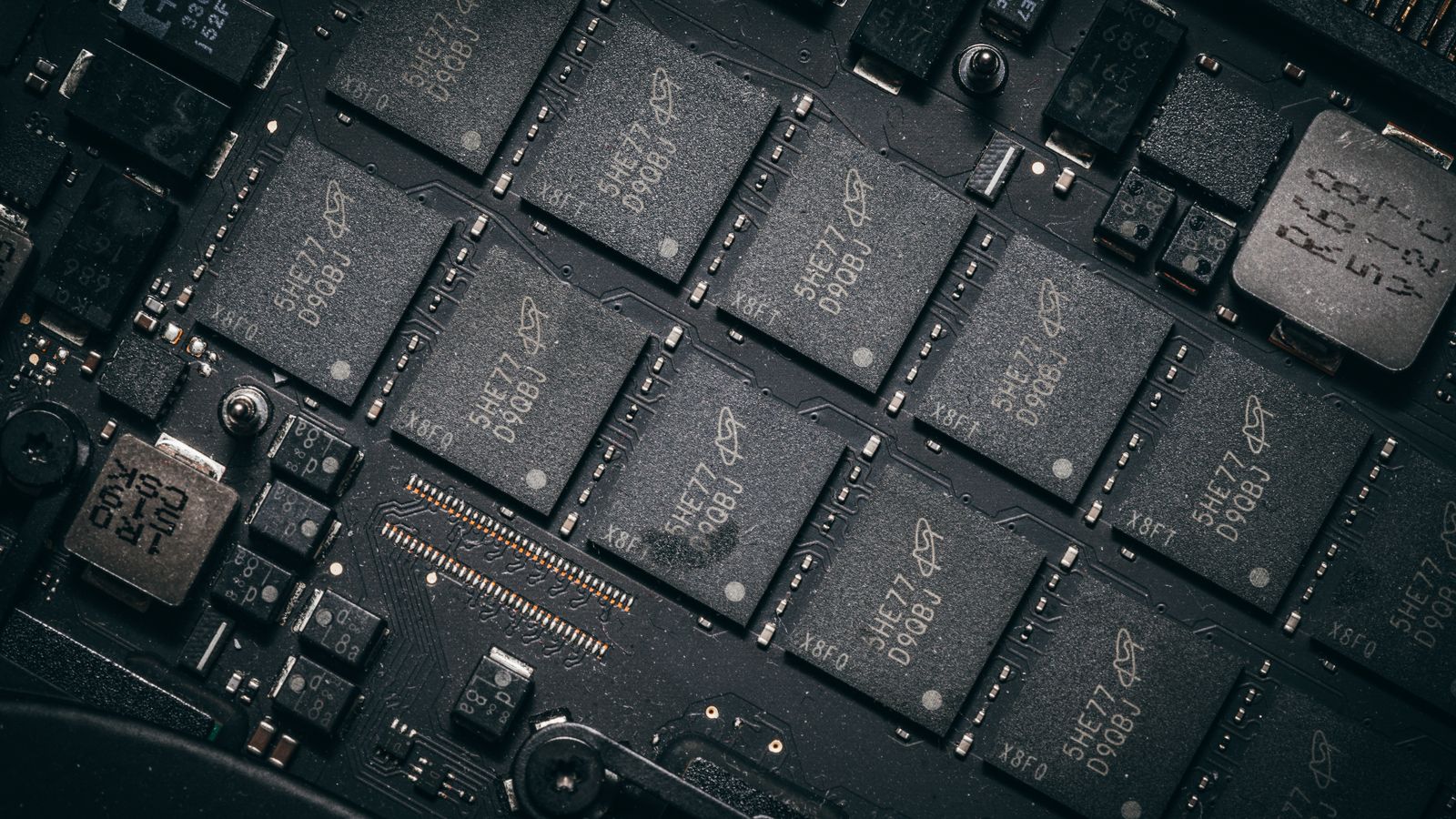 Detailed view of electronic circuit board components showcasing microchips and technology intricacies.