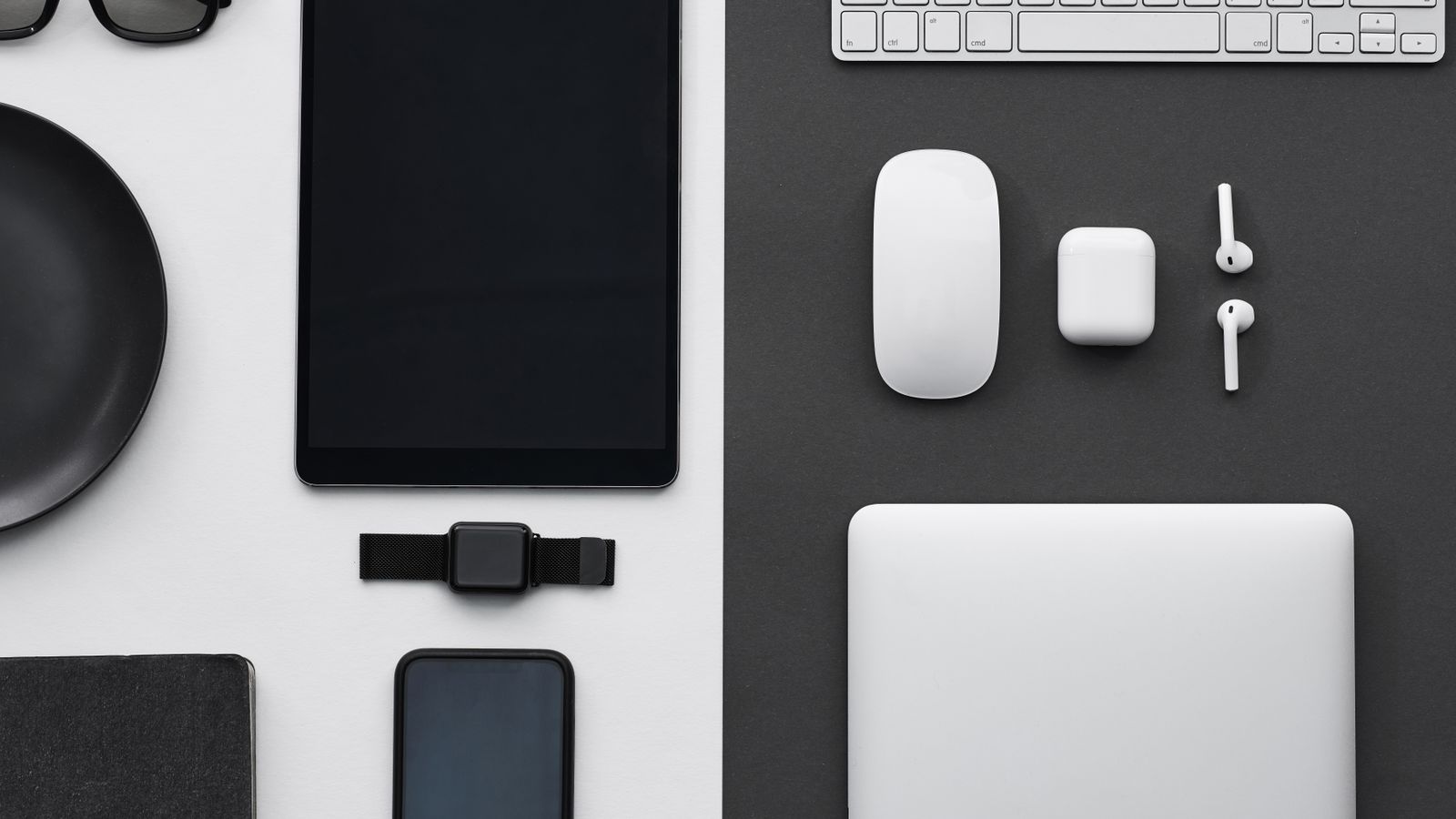Stylish flatlay of modern tech gadgets including tablet, smartphone, smartwatch, and accessories.