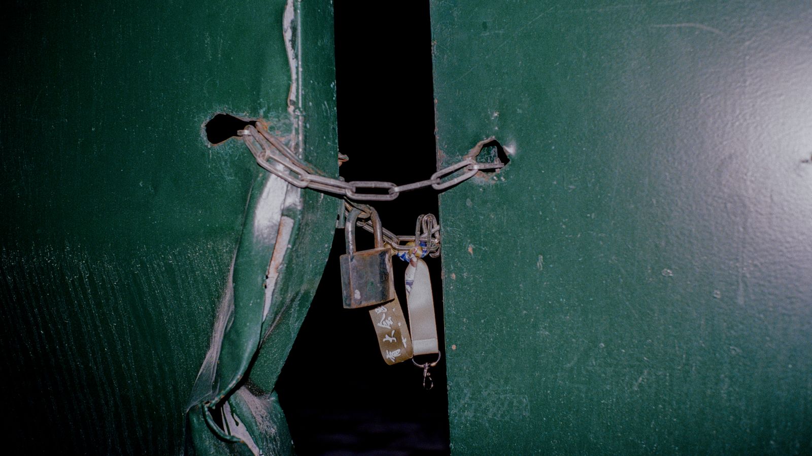 Padlock and key on a table in front of dark server racks
