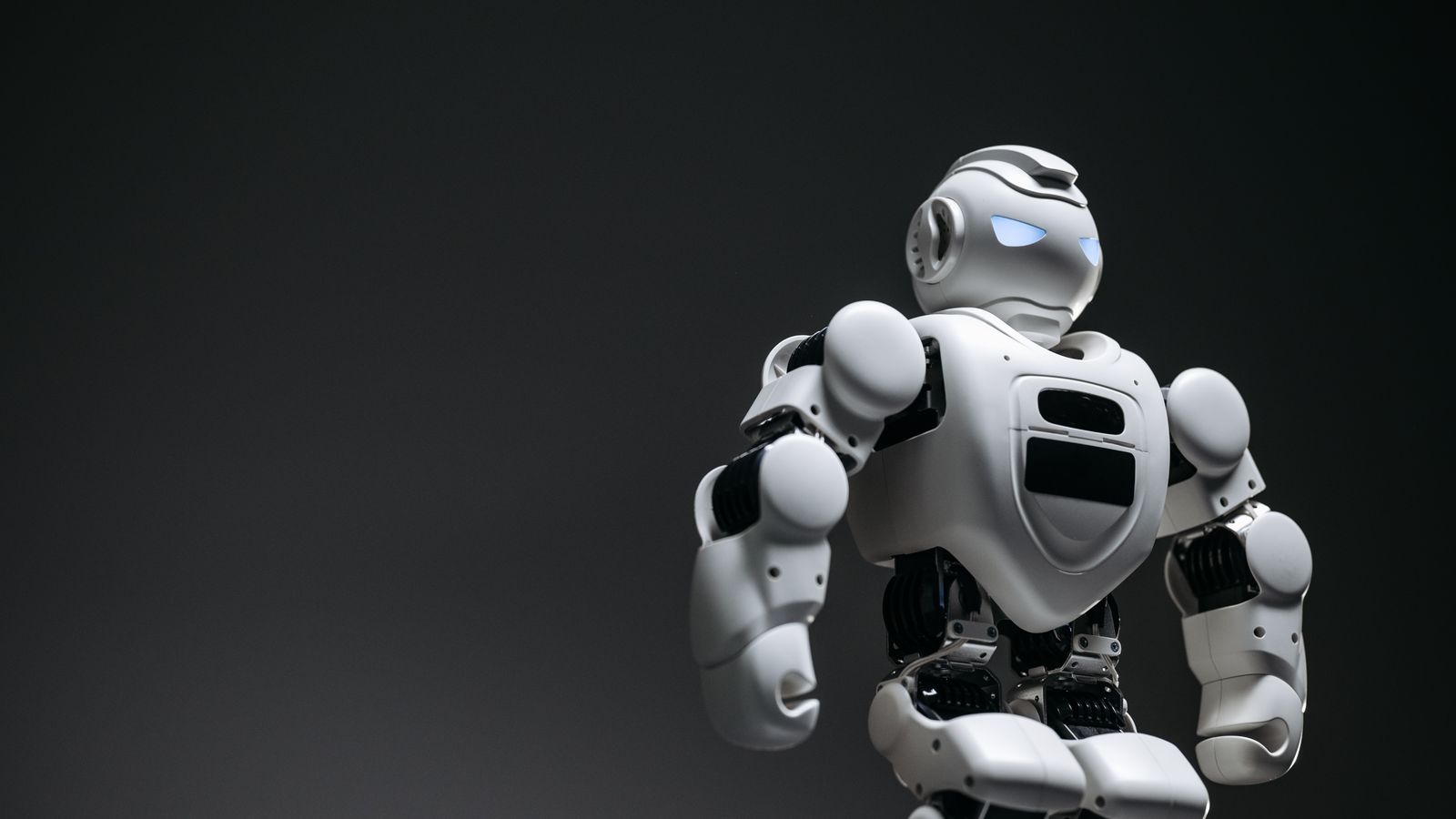 Four-wheeled autonomous robot in a long warehouse aisle