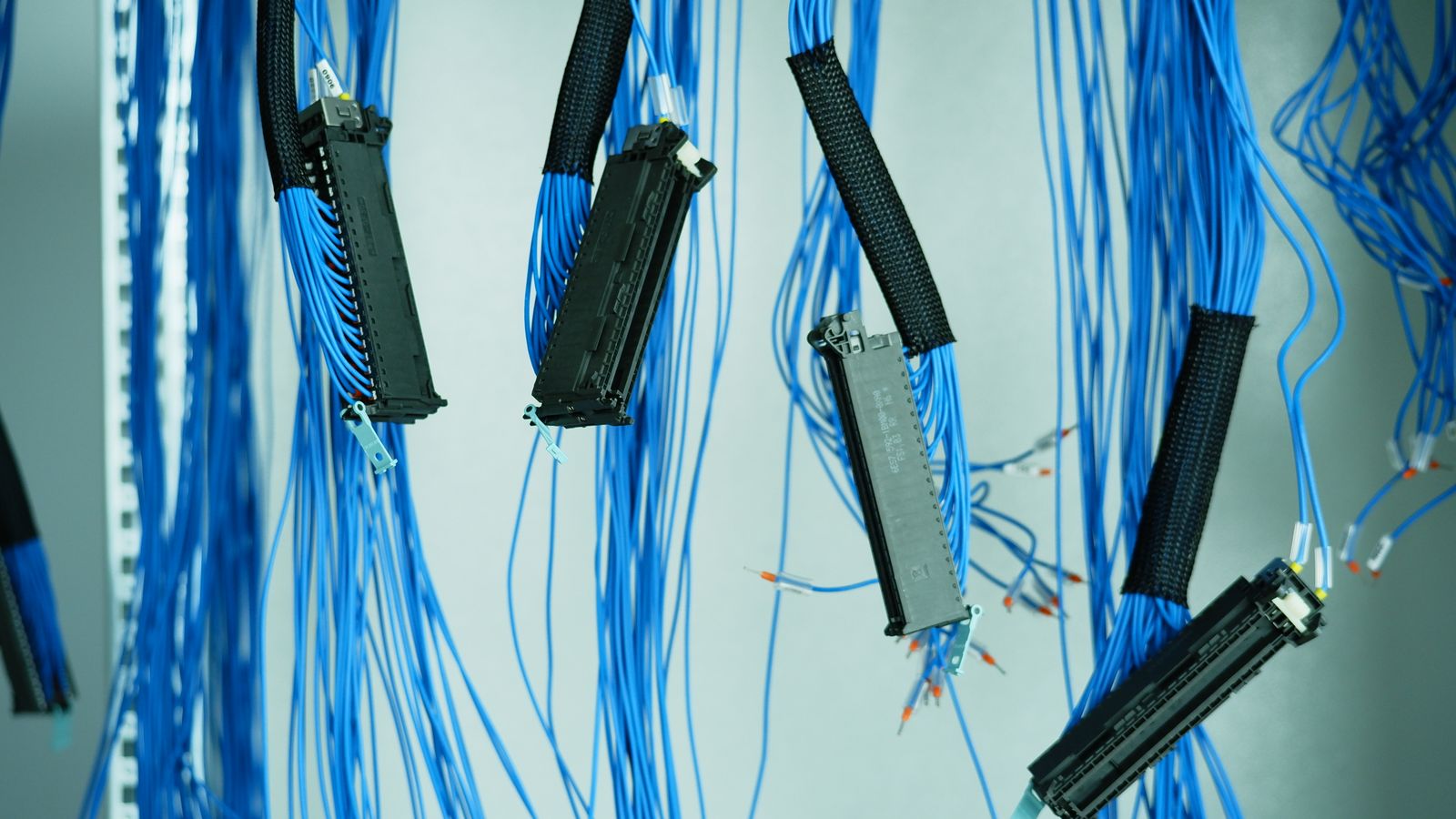 Analyst seen from behind facing a wall of blurred monitoring screens