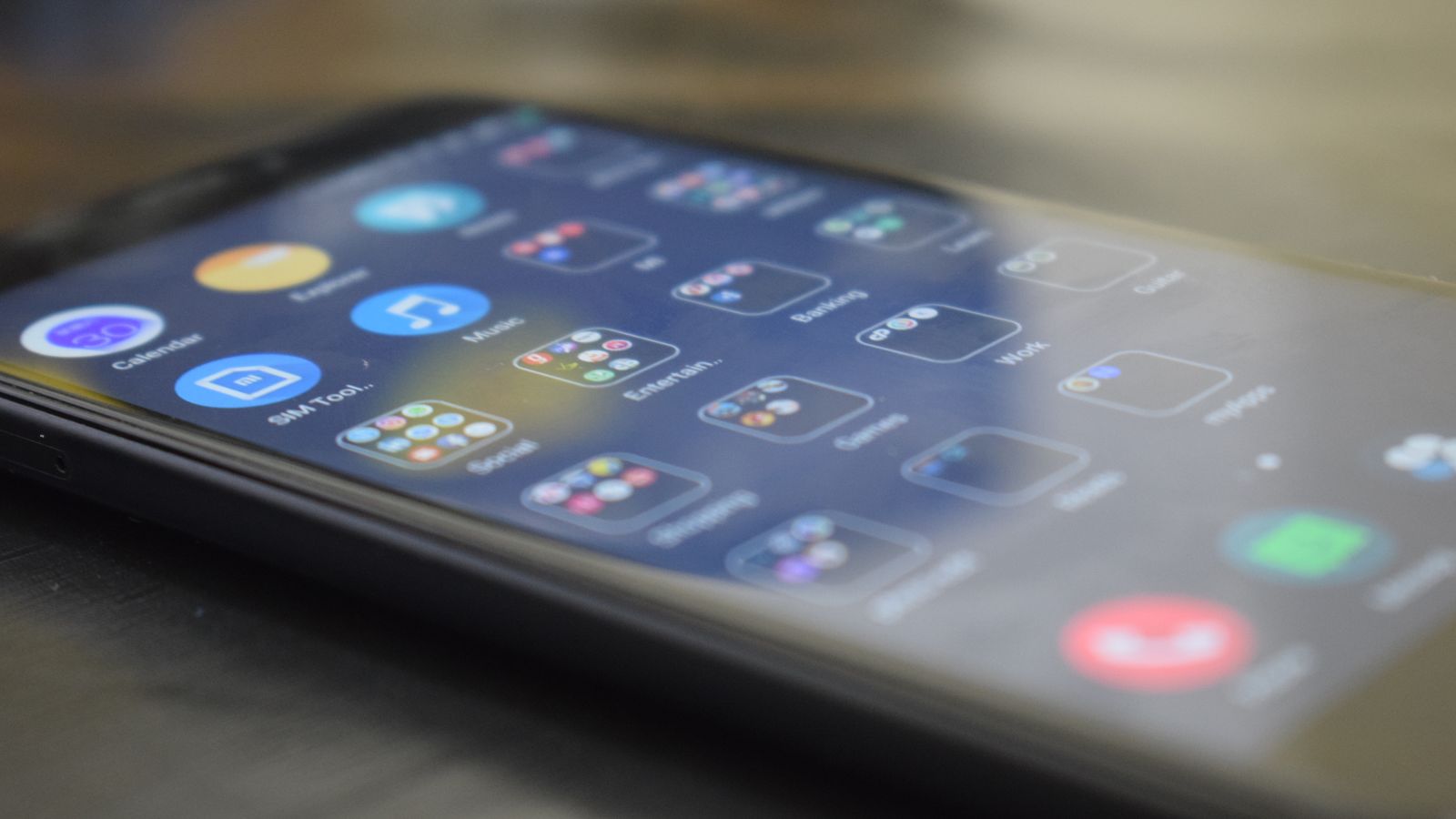 Close-up shot of a smartphone screen showing various app icons, indicating digital technology use.