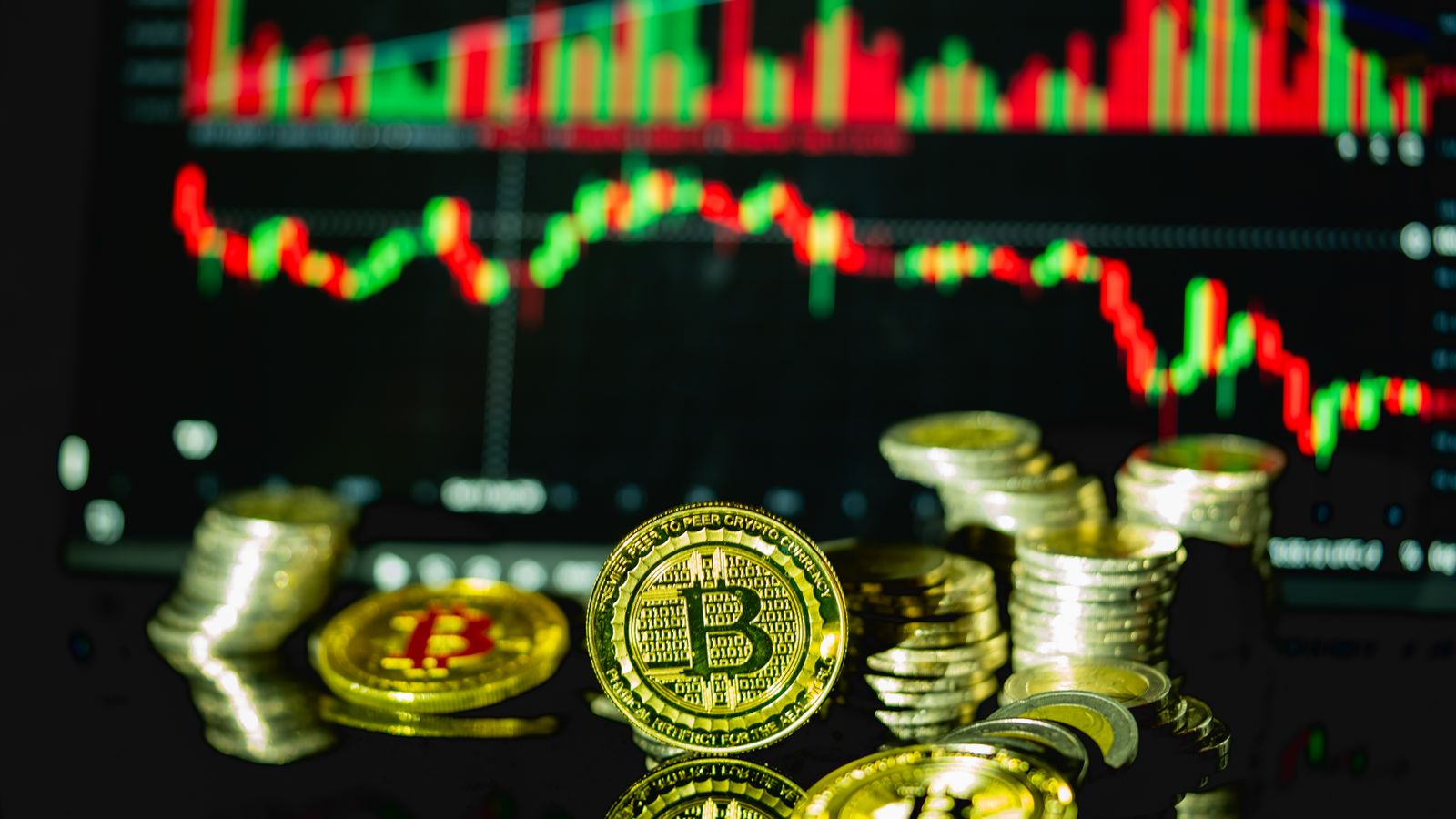 Golden bitcoins stacked in front of a fluctuating financial chart, symbolizing cryptocurrency trading.