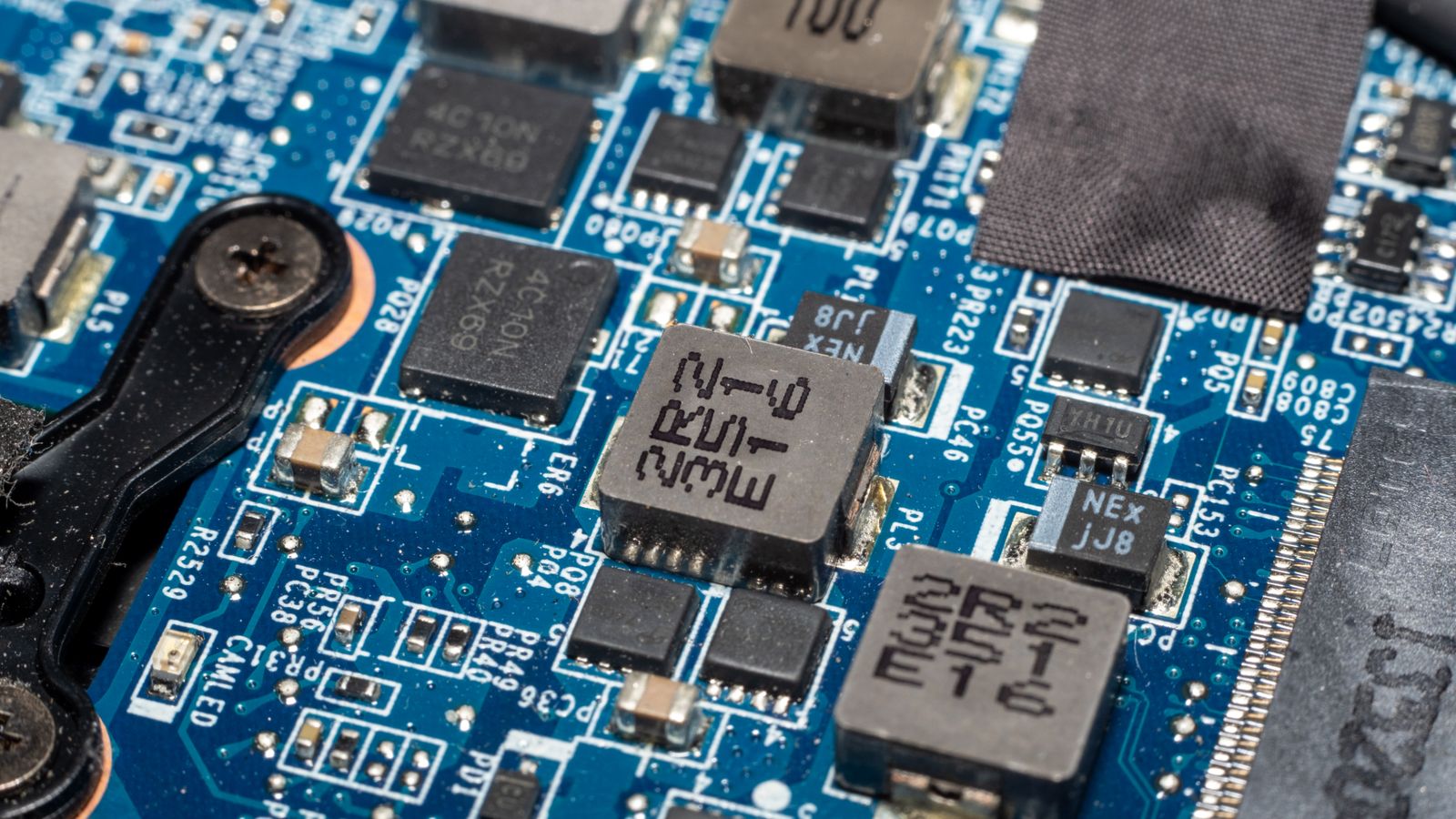 Close-up view of an electronic circuit board showcasing chips and intricate patterns.