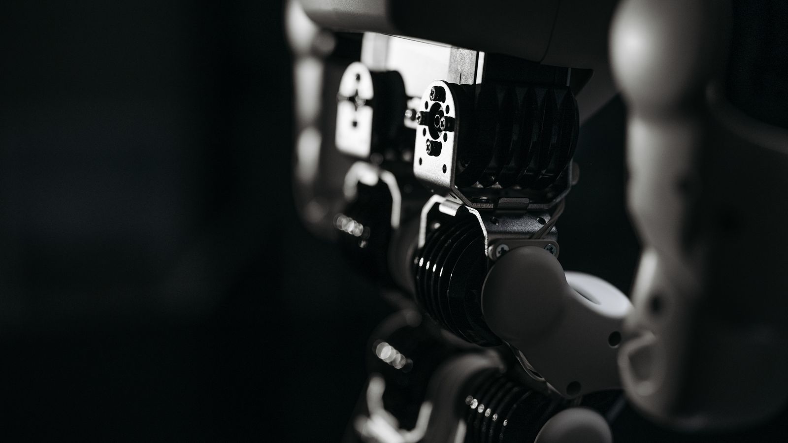 Detailed close-up of a robot's mechanical components, emphasized by moody studio lighting.