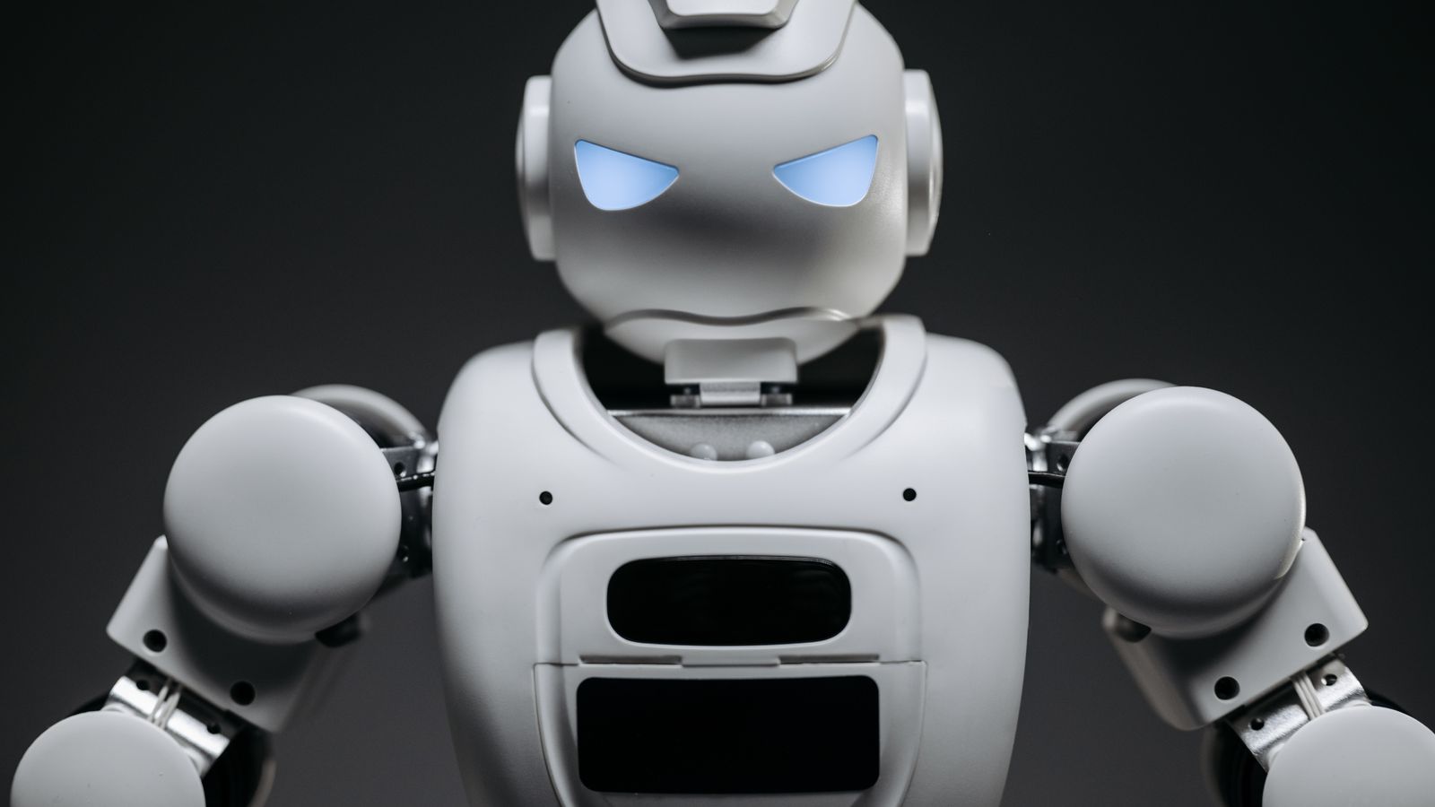 Detailed studio shot of a modern robotic toy with a dark background, showcasing technological design.