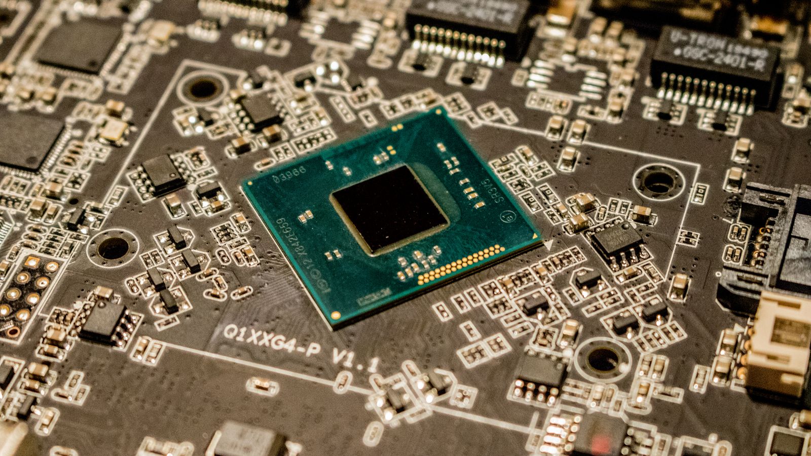 Detailed view of a microchip on a printed circuit board, showcasing electronic components.
