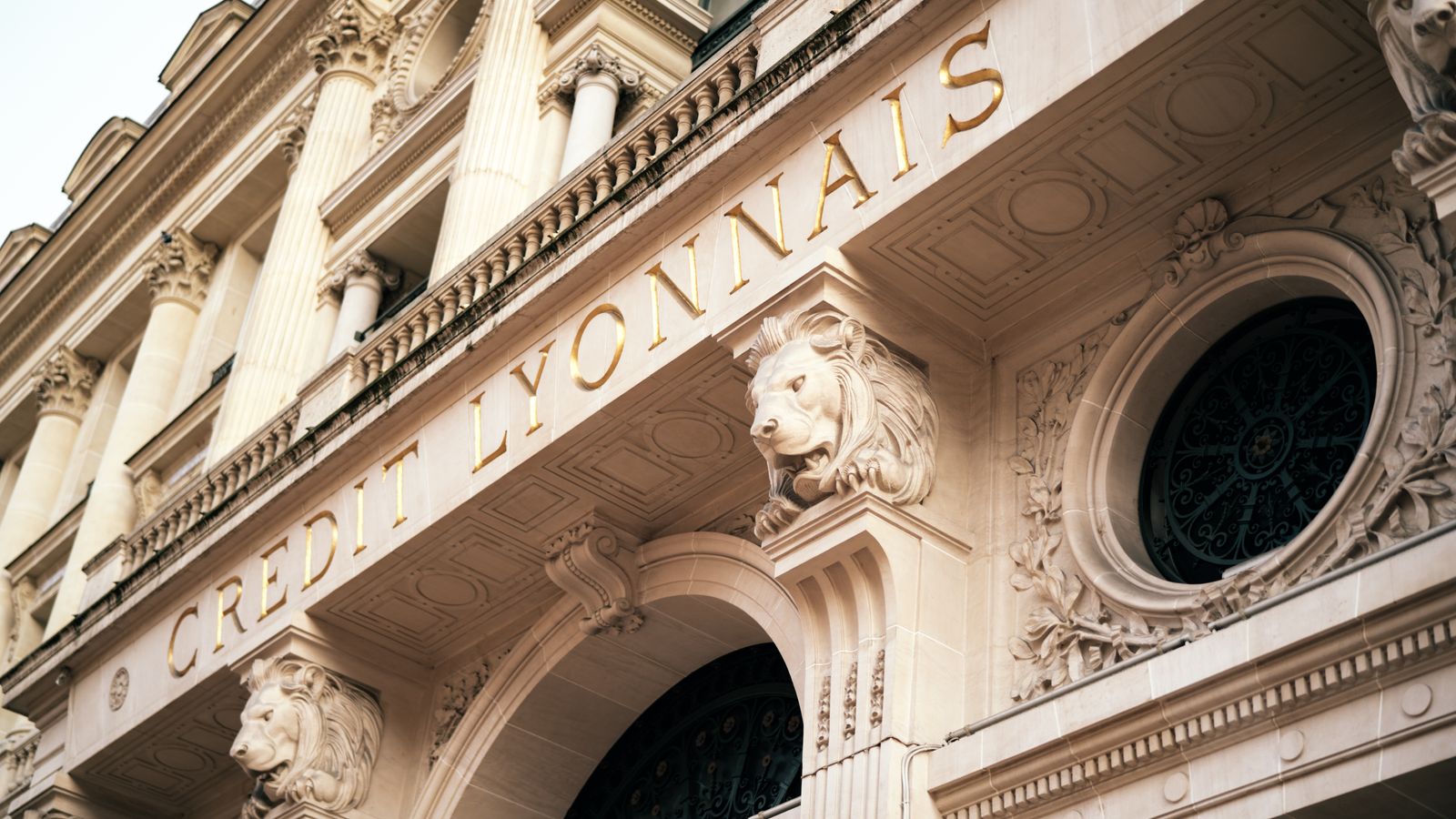 Elegant facade of Credit Lyonnais in Paris showcasing detailed architectural sculpture and ornate carvings.
