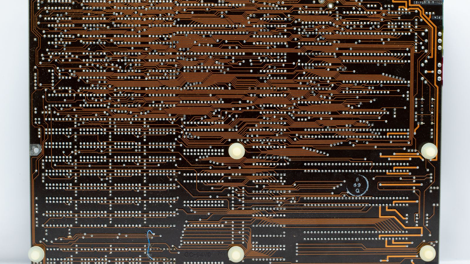 Close-up of a retro circuit board showcasing intricate copper traces and electronic components.
