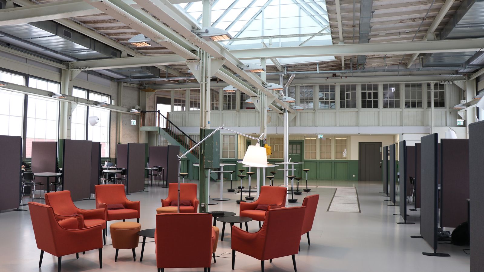 Spacious modern industrial workspace with red chairs in Winterthur, Zurich.