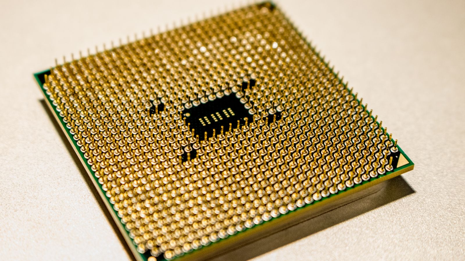 Detailed close-up of a golden microprocessor chip, ideal for technology concepts.