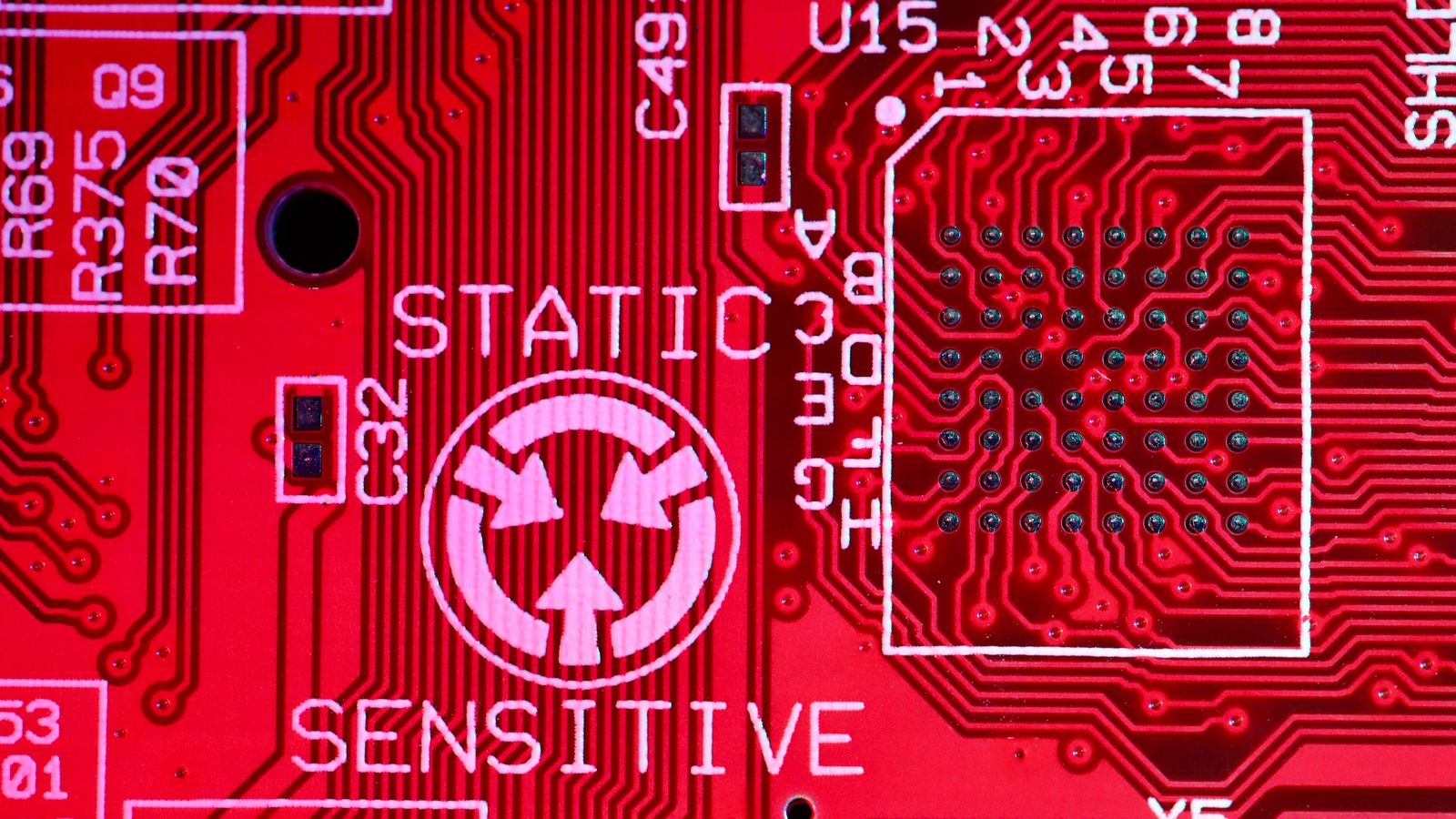 Background of modern colorful printed board of digital device with electric circuits and written words with numbers on red surface