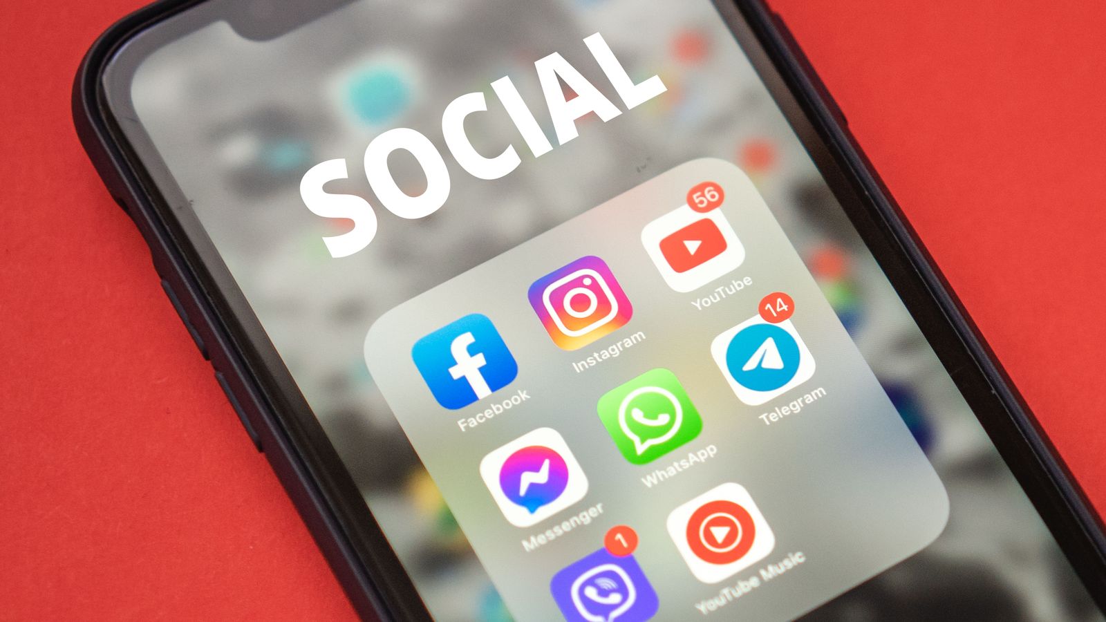 Close-up of a smartphone showing popular social media apps on screen.