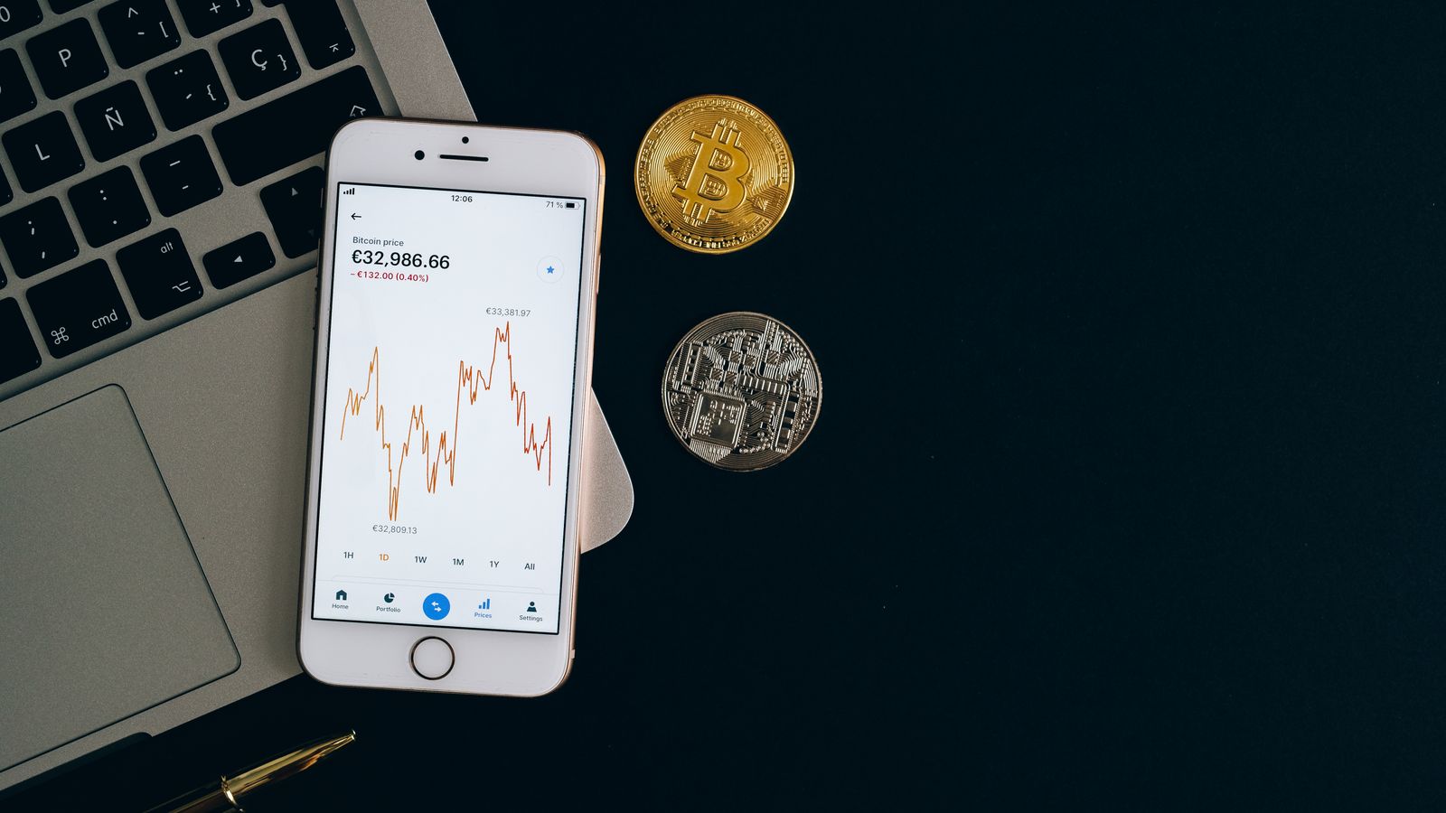 Smartphone displaying Bitcoin price chart alongside Bitcoin and Ethereum coins on black background.