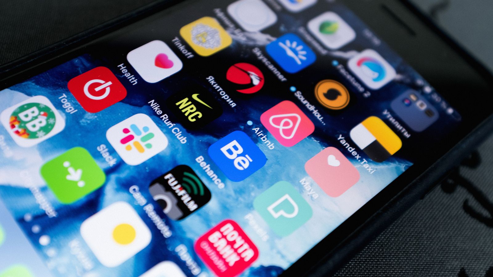 Detailed view of smartphone displaying multiple app icons on screen, highlighting technology use.
