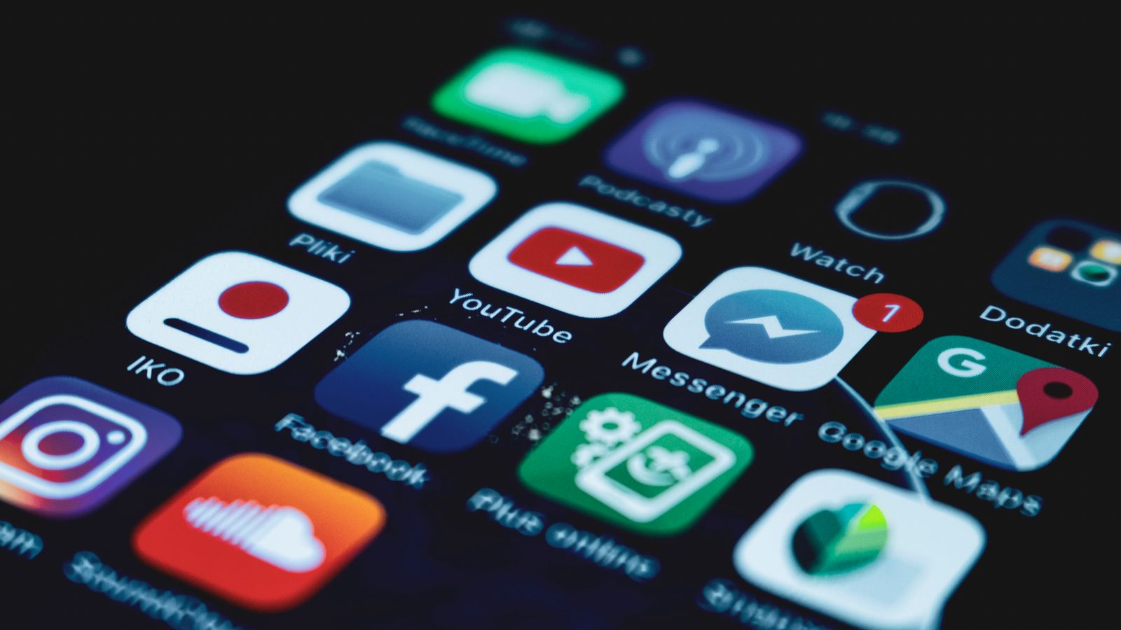 Detailed close-up view of a smartphone screen displaying various popular social media app icons.