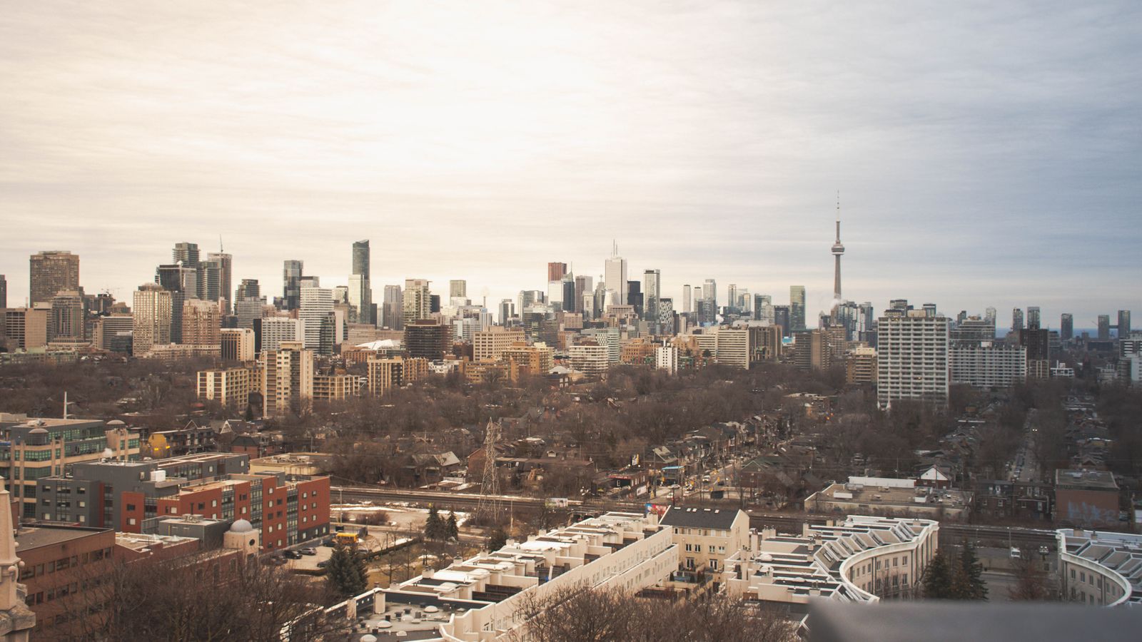 A stunning view of Toronto's skyline featuring the iconic CN Tower under an overcast sky.