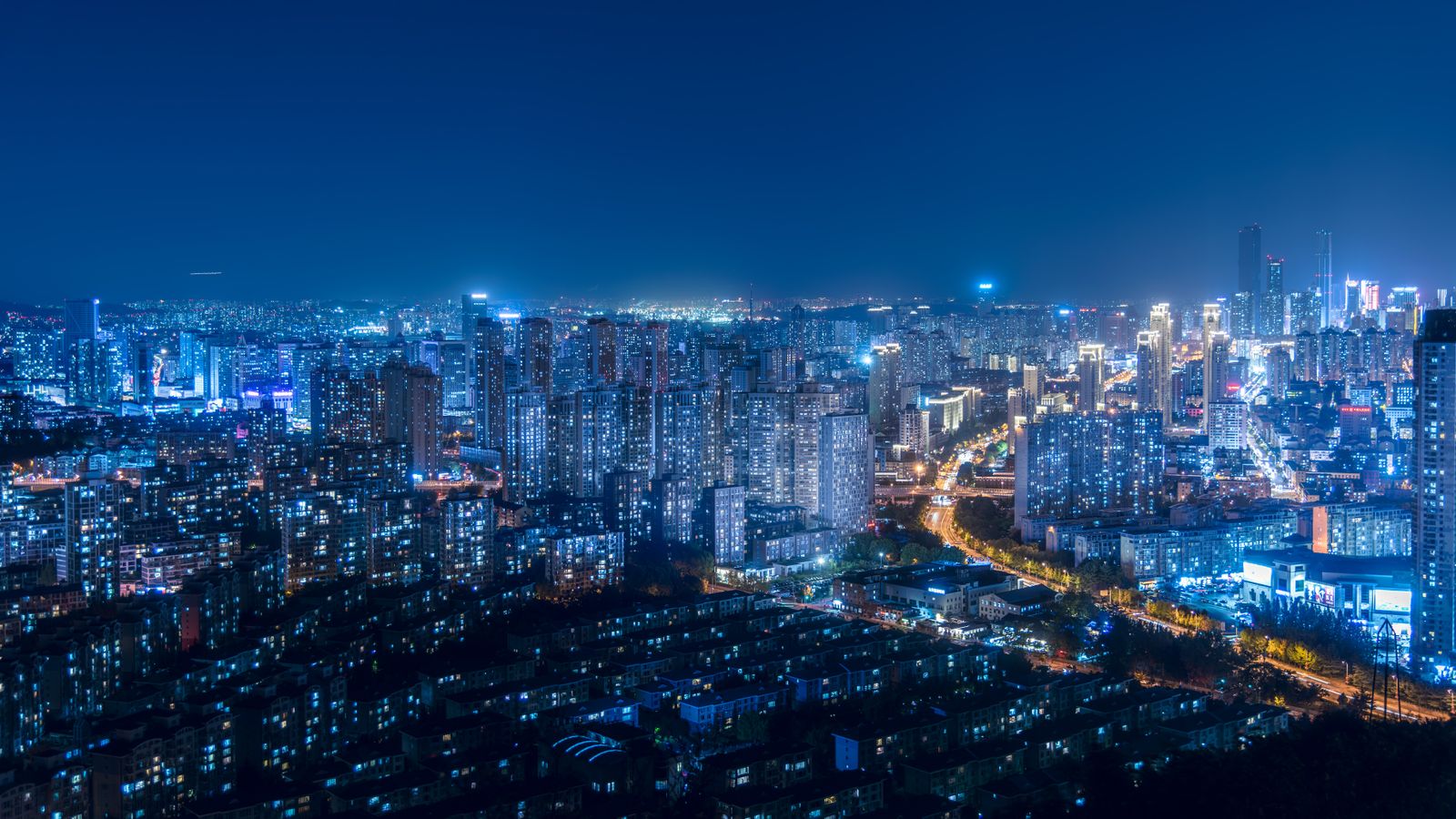 A breathtaking cityscape with illuminated skyscrapers and vibrant urban lights during the night.