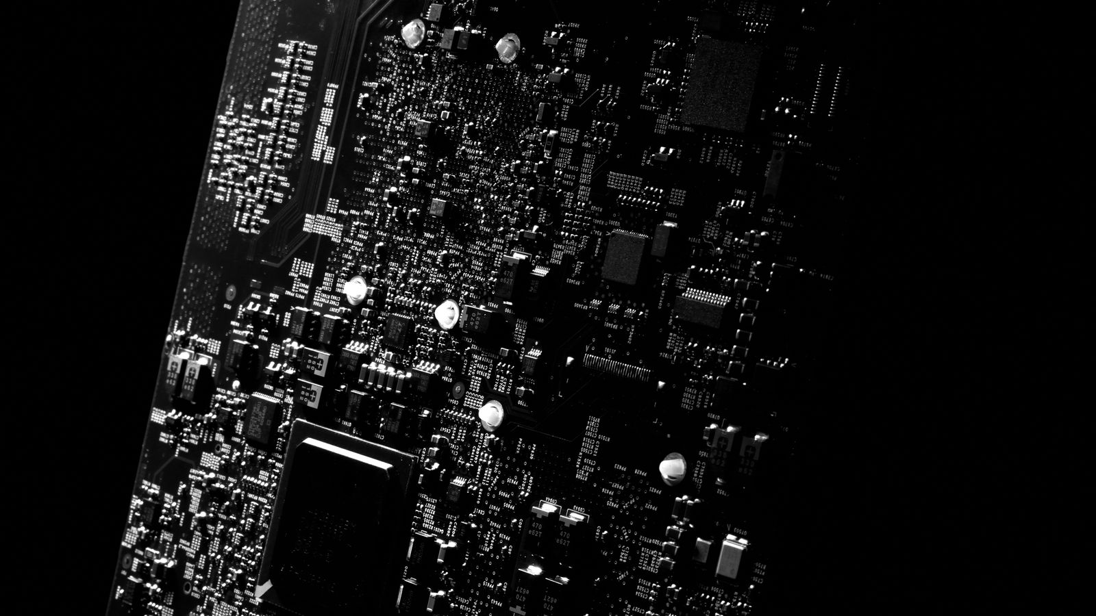 Detailed black and white close-up of a circuit board showcasing modern technology.