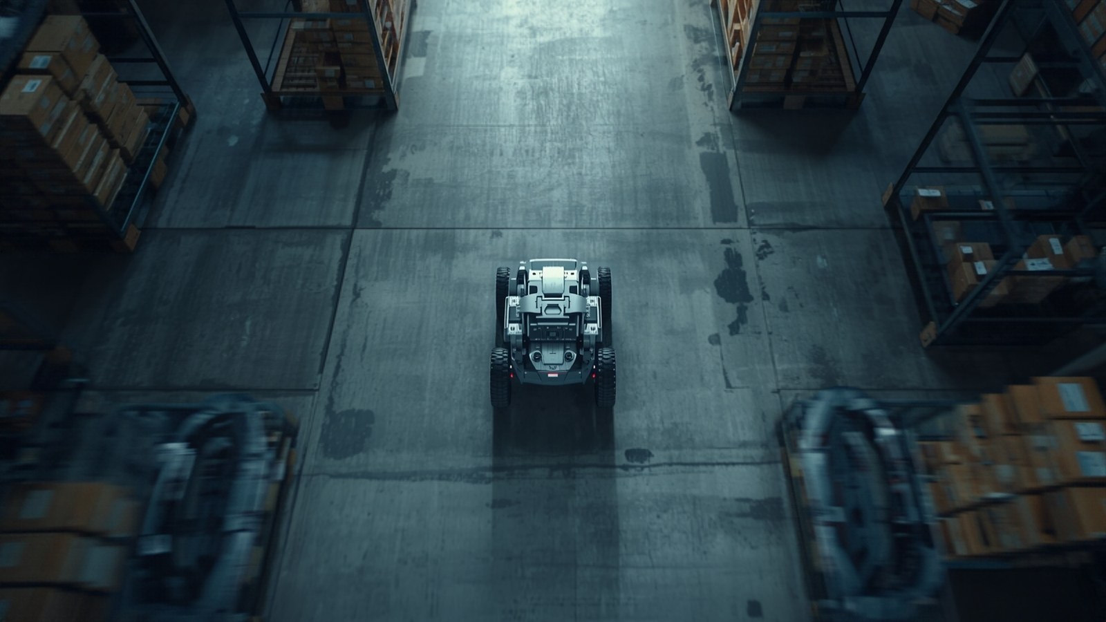 Autonomous mobile robot moving through a warehouse aisle, overhead view