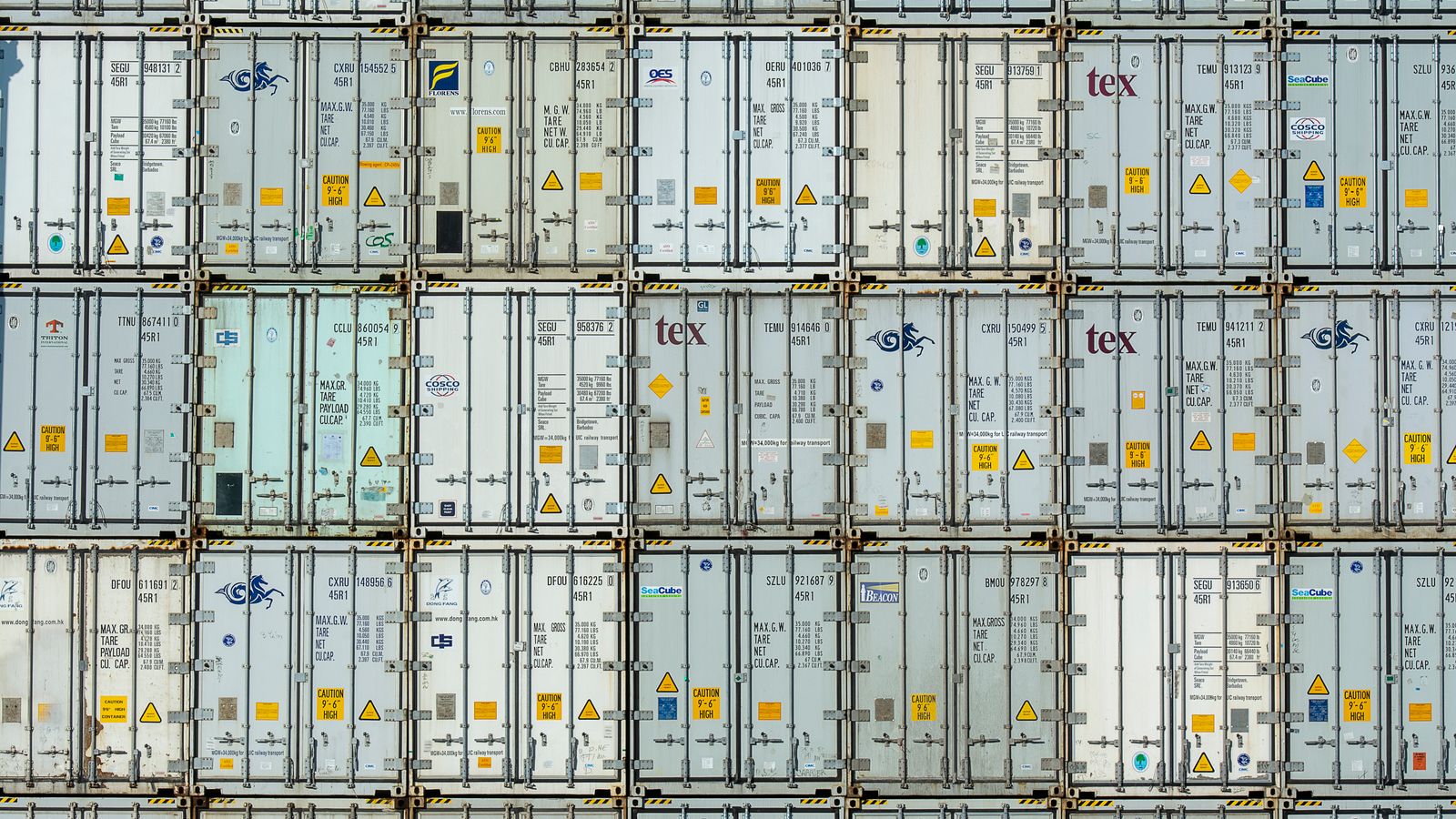 Dark data-center aisle lined with server racks under ceiling lights