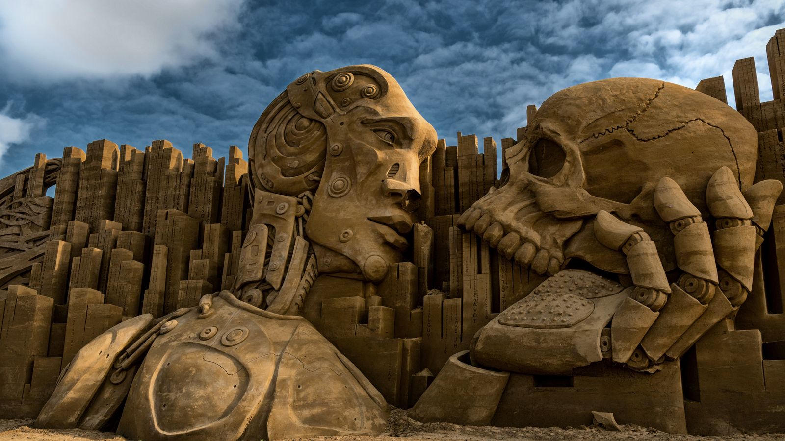 Intricate sand sculpture depicting a robot and skull in Ringkøbing, Denmark.