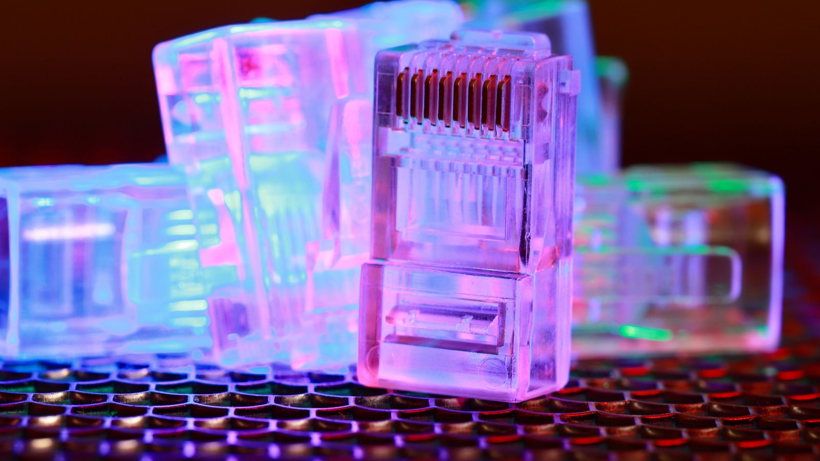 Detailed view of fiber optic cables connected to a server rack, showcasing modern technology.