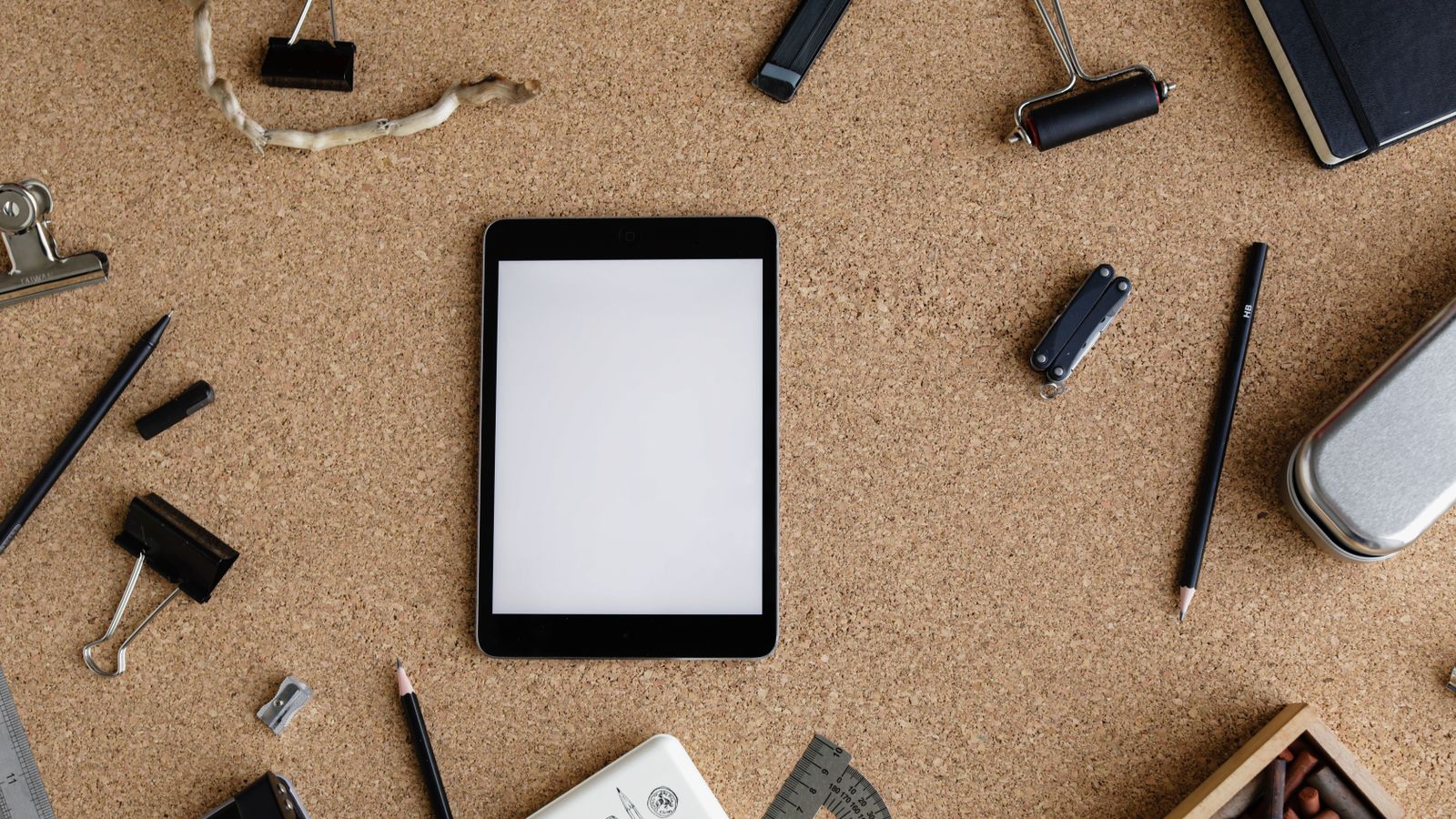 Modern workstation setup showcasing laptop, smartphone, and financial data for business use.