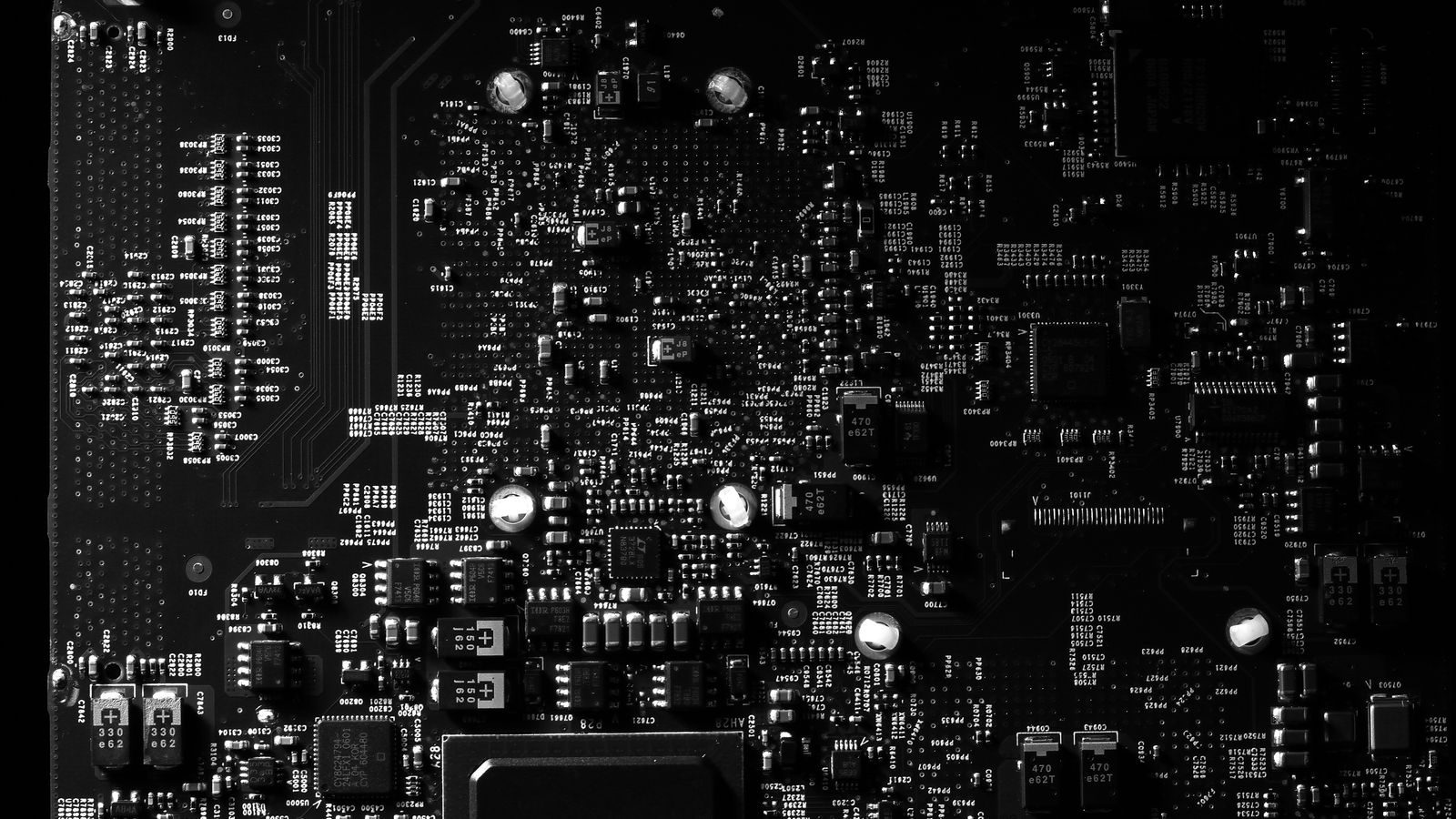 Detailed black and white photo of a circuit board showing intricate components, perfect for tech projects.