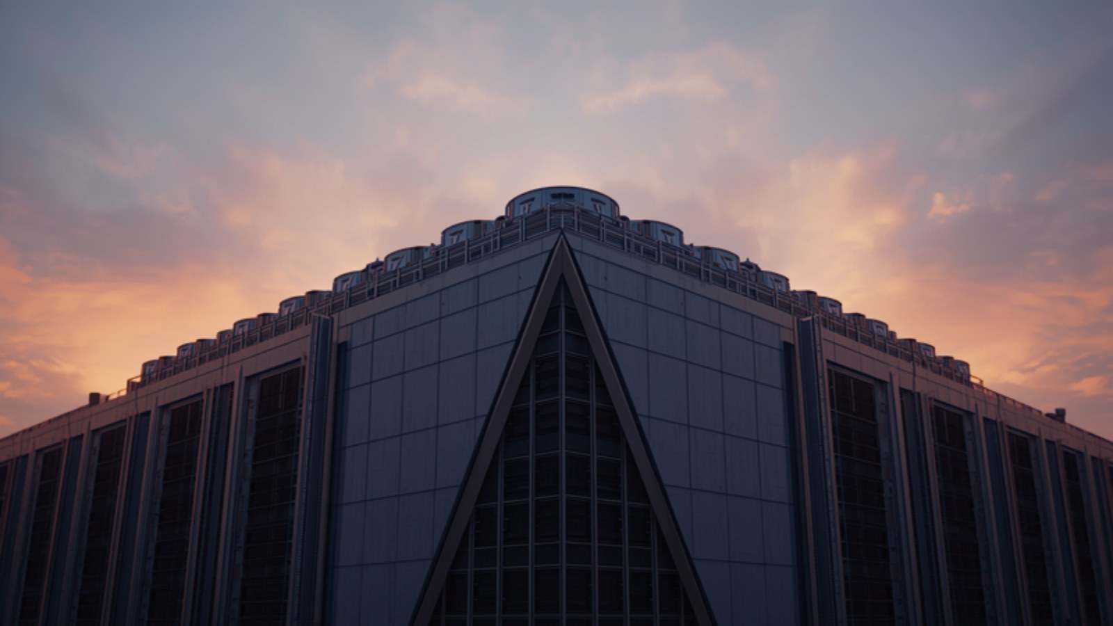 Data-center facade with rooftop cooling units under an evening sky