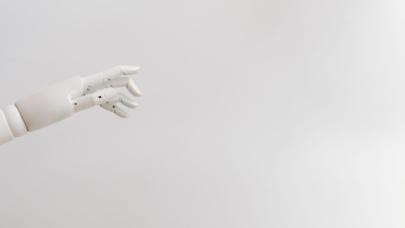 Minimalist image of a robotic hand reaching out on a white background.