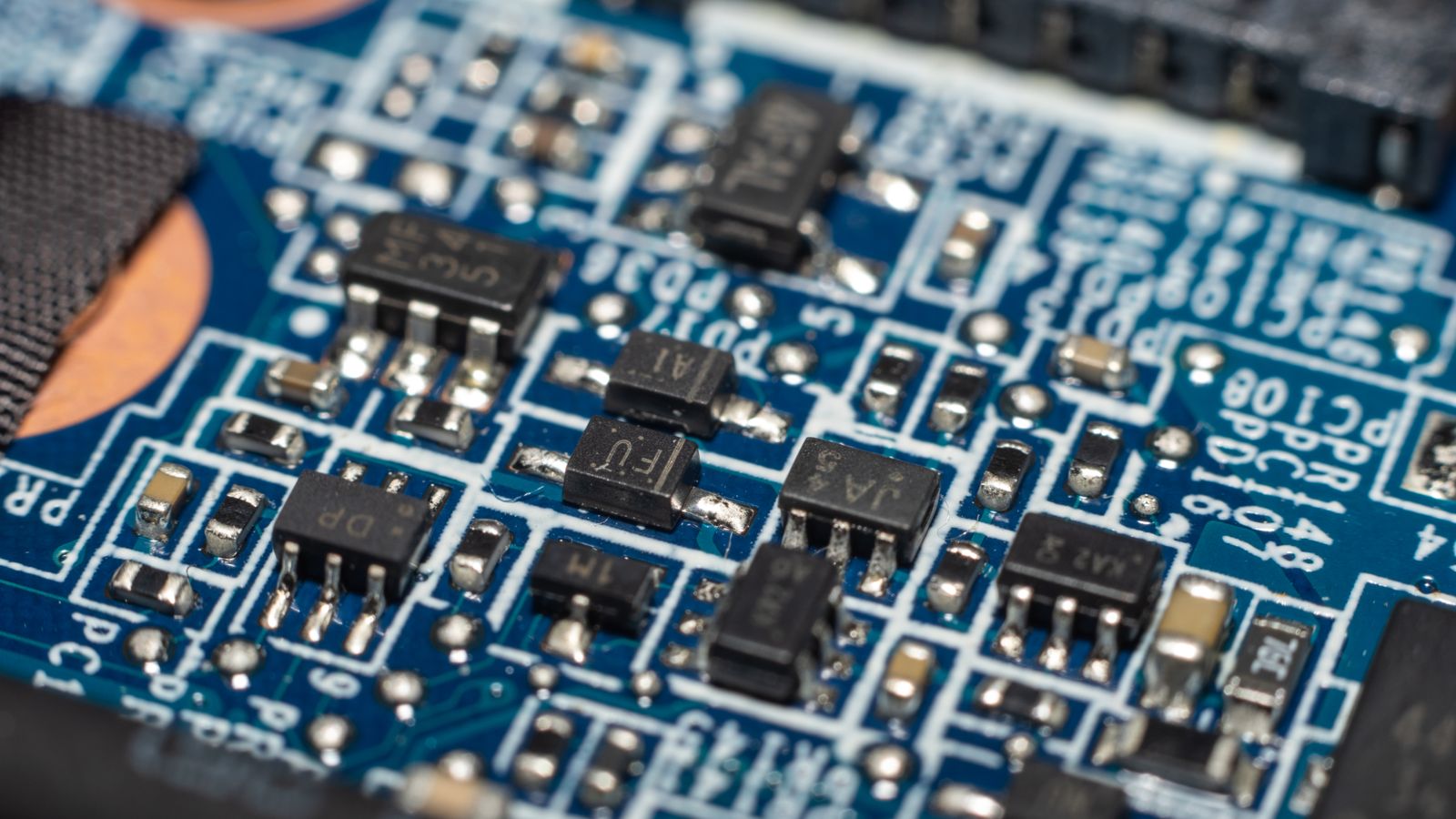 Detailed macro shot of electronic circuit board with chip and components.