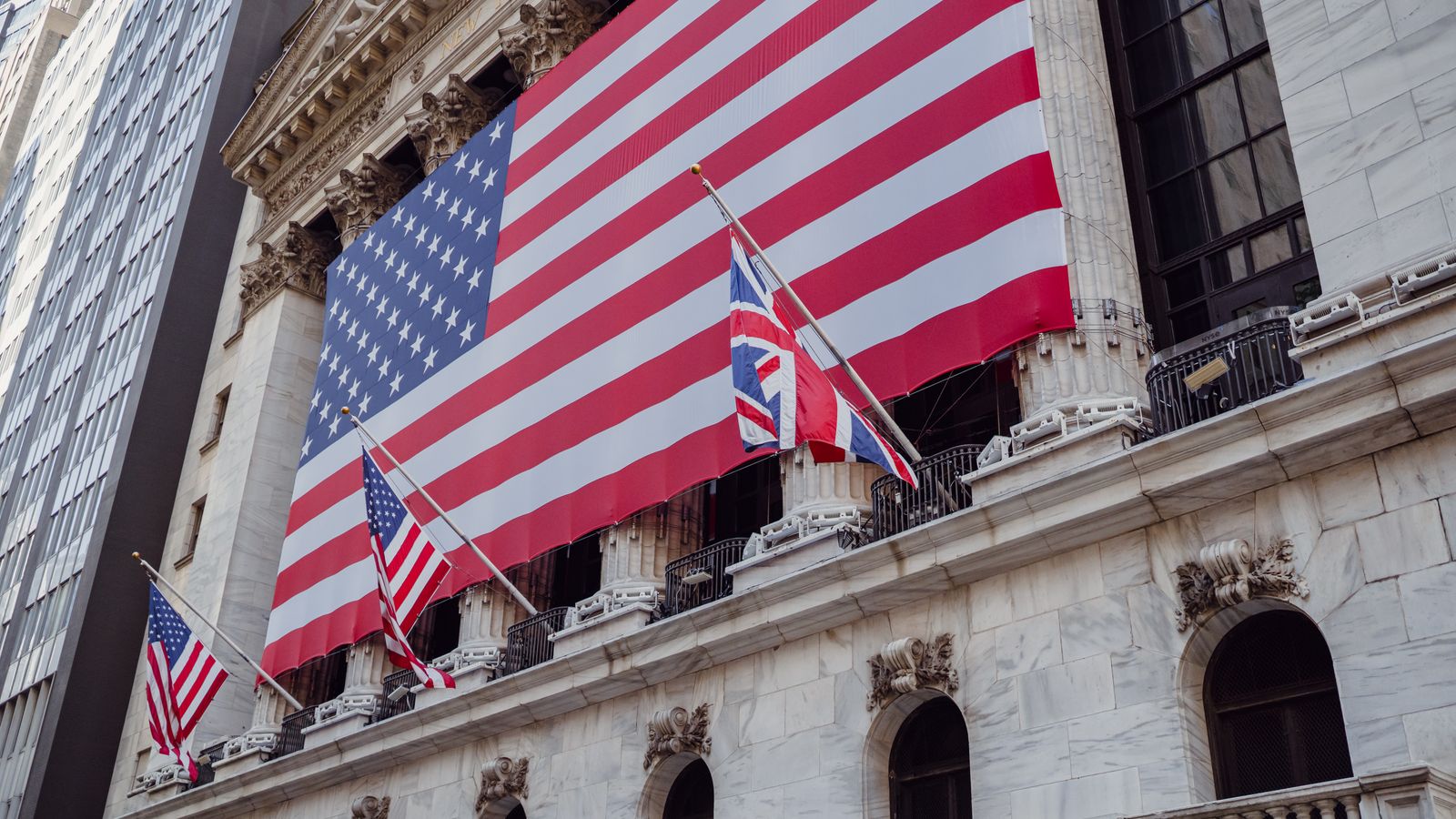 American flag on a historic building exterior symbolizing patriotism and national pride.