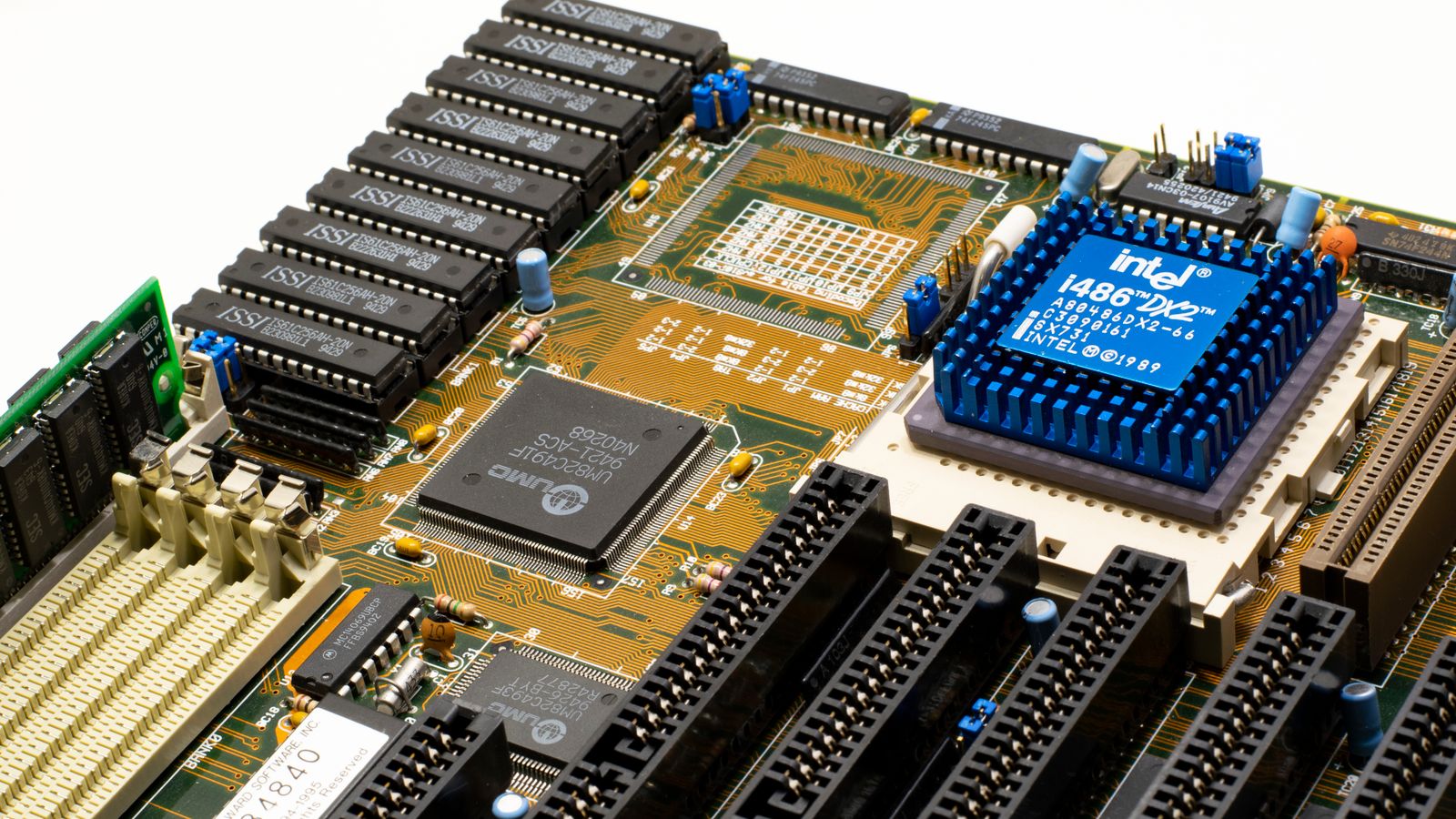 Close-up of vintage Intel 486DX2 CPU on a classic motherboard with electronic components.