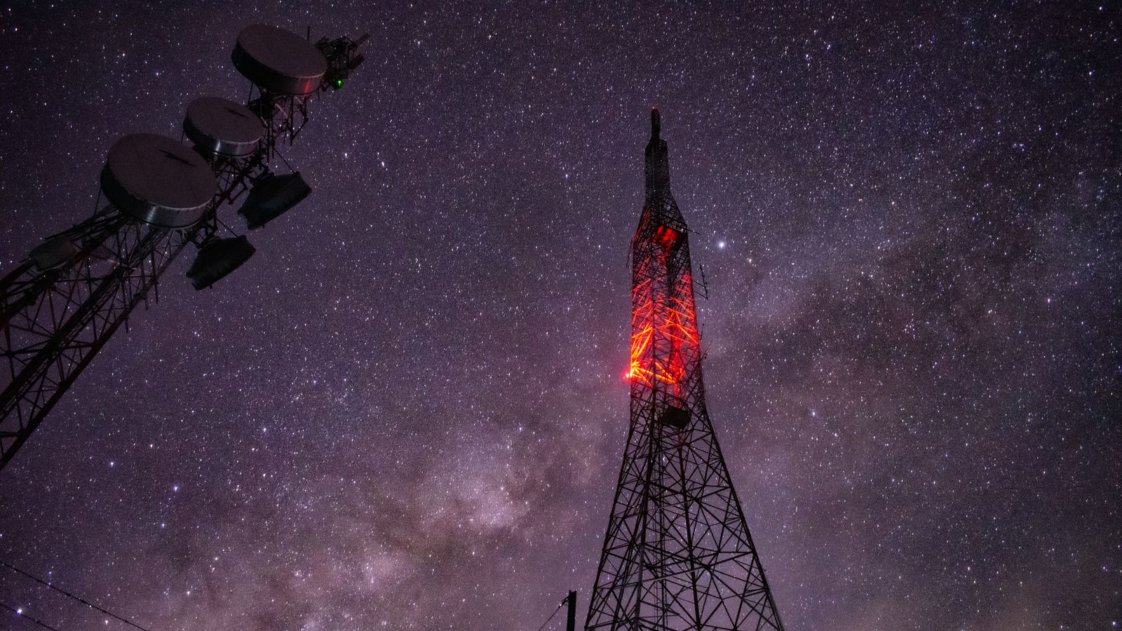 Stunning capture of a communication tower under a star-filled night sky.