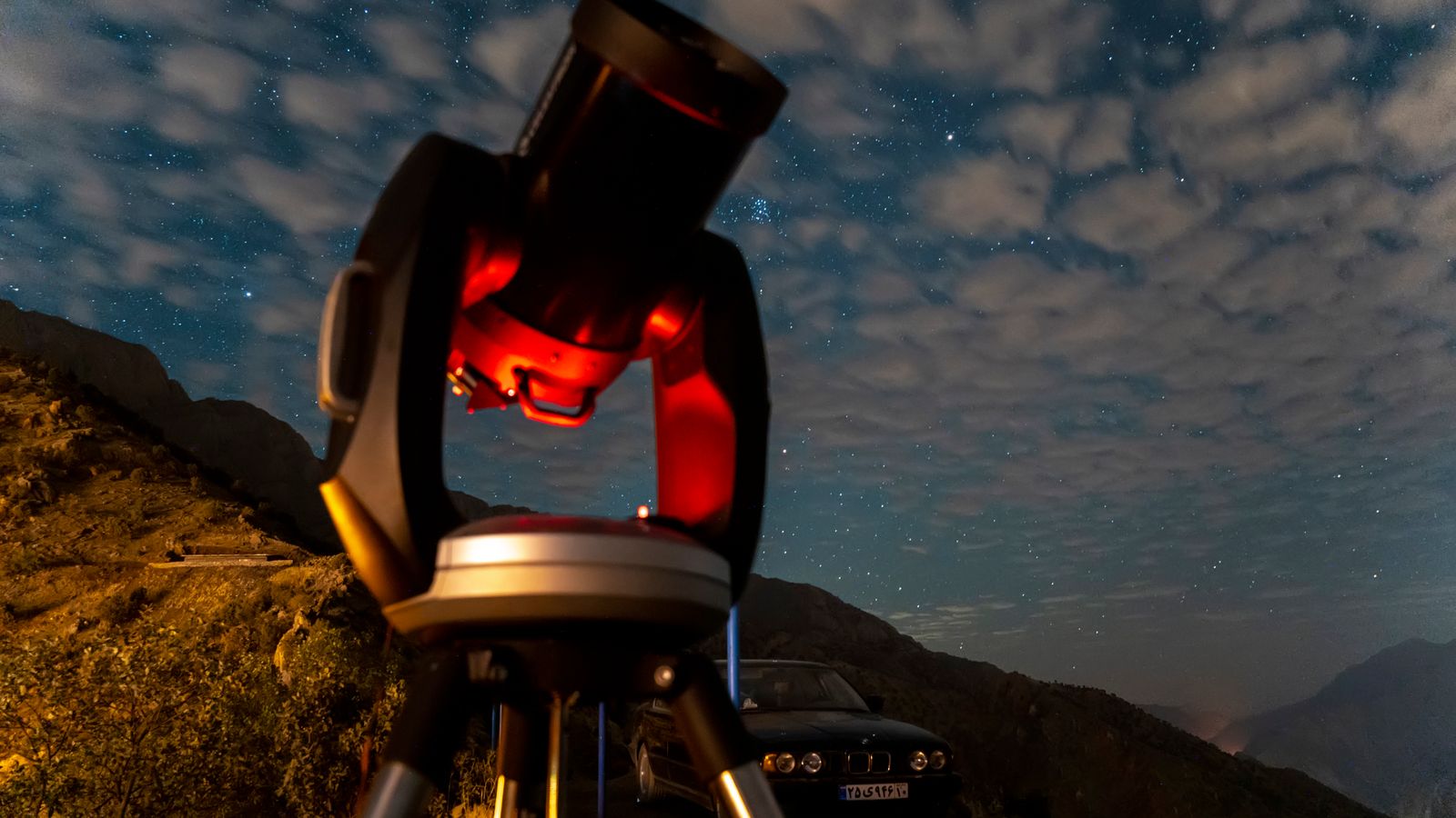 A mesmerizing view of a telescope under a starry night sky in Nodesheh, Iran.