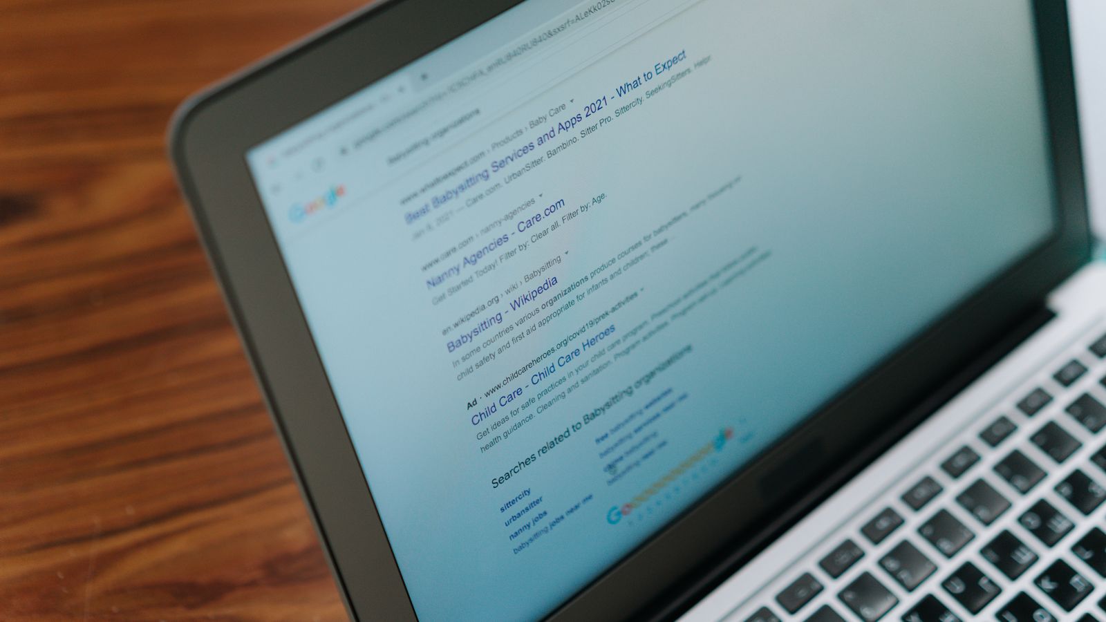 A close-up view of a laptop displaying a search engine page.