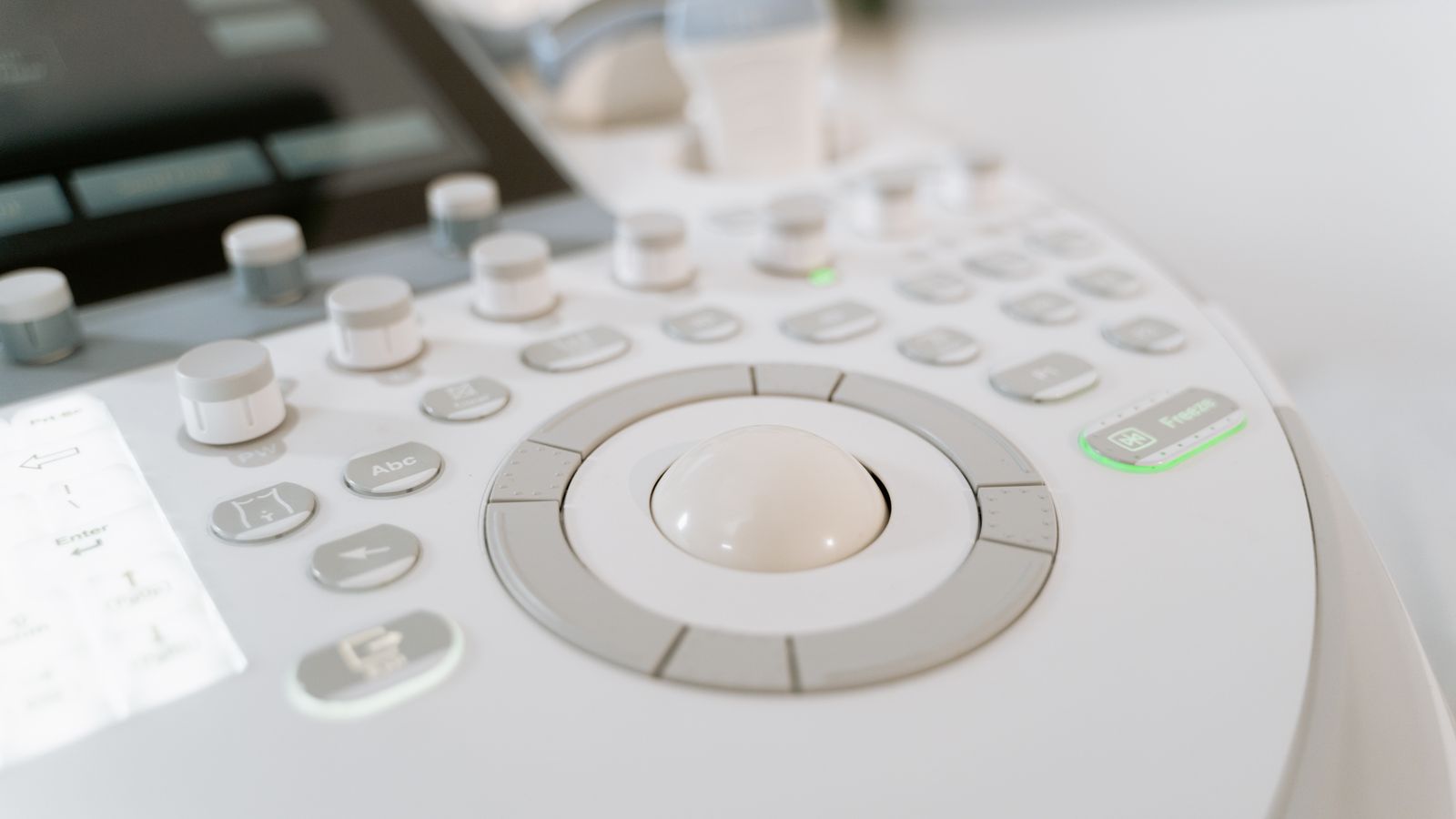 Detailed close-up of ultrasound machine controls in a medical facility.