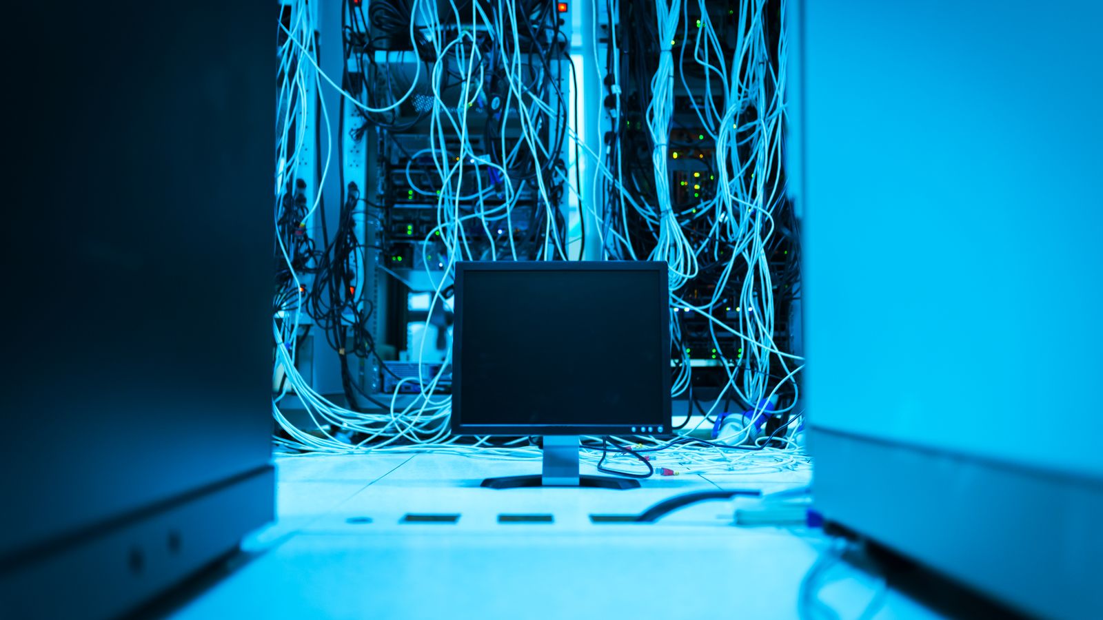 Detailed view of fiber optic cables connected to a server rack, showcasing modern technology.