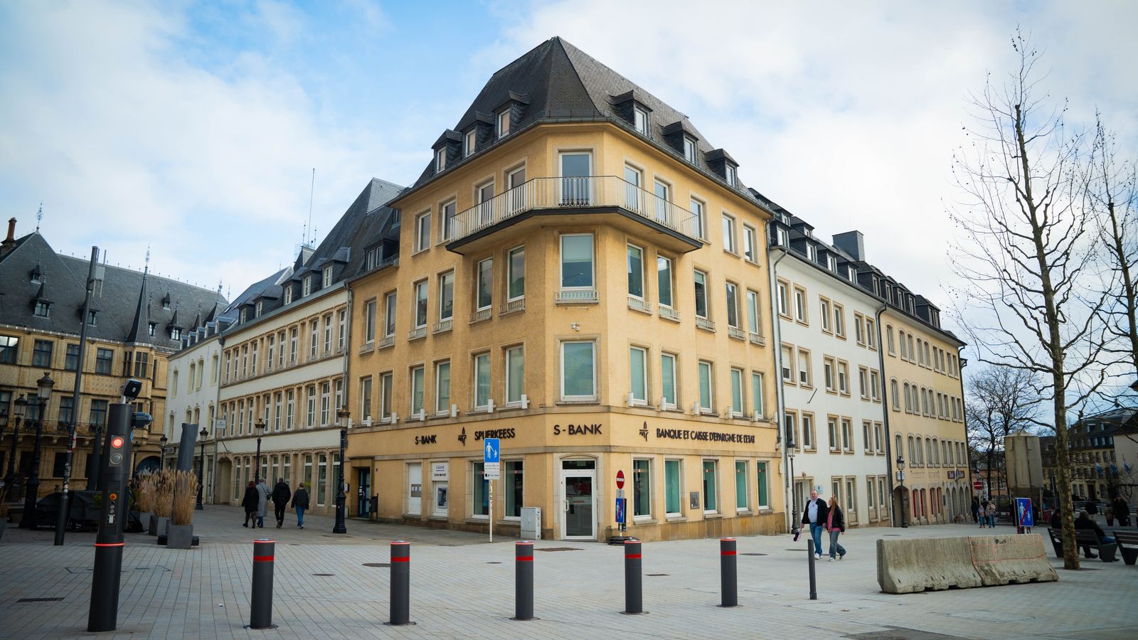 A scenic view of a bustling town square in Luxembourg city, showcasing classic European architecture.