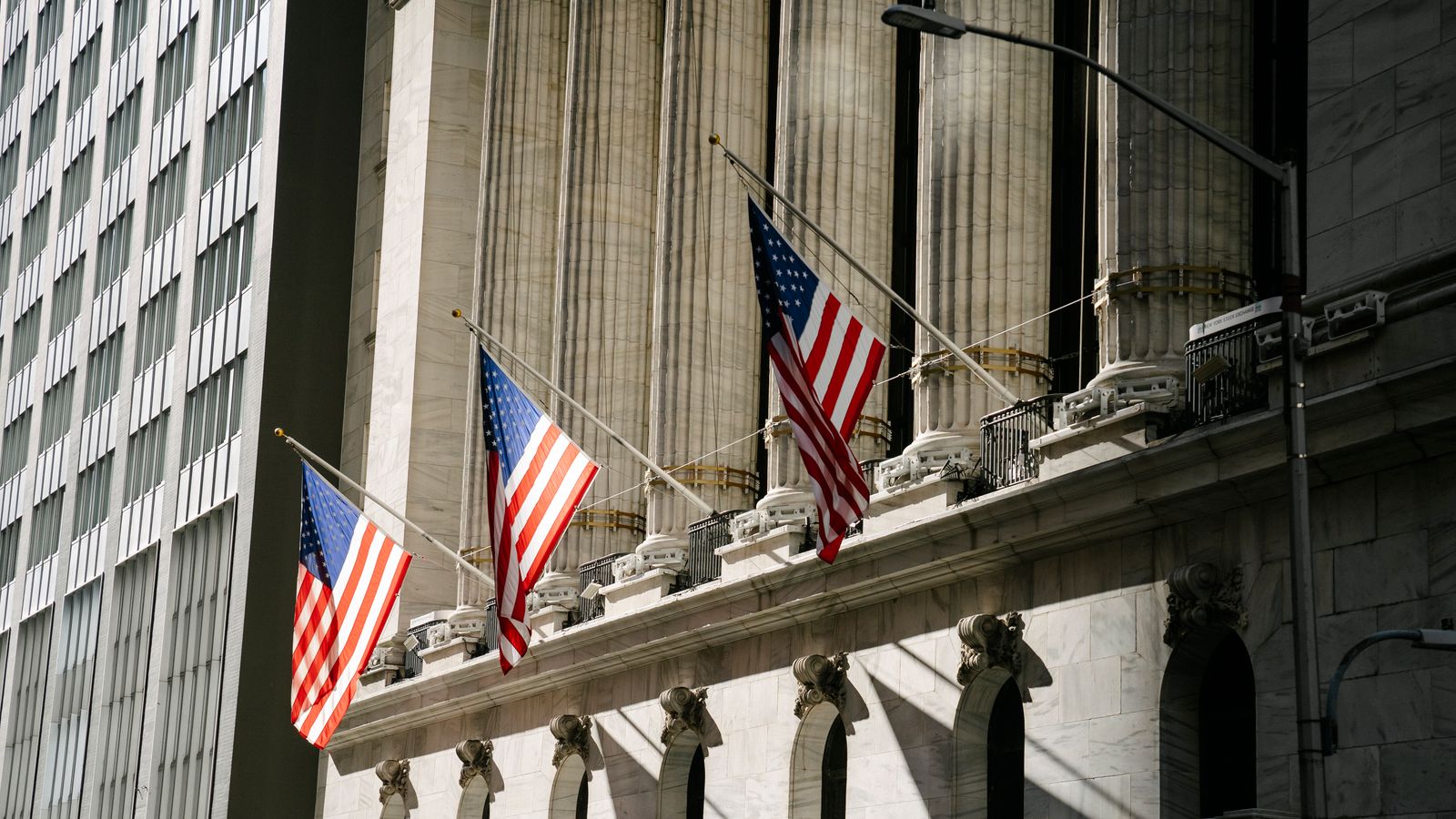 Grand architectural building adorned with American flags, symbolizing patriotism and history.
