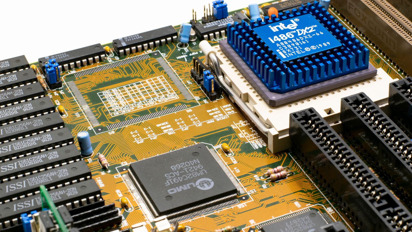 Detailed view of an Intel i486 DX2 CPU installed on a vintage motherboard with chips and circuits.